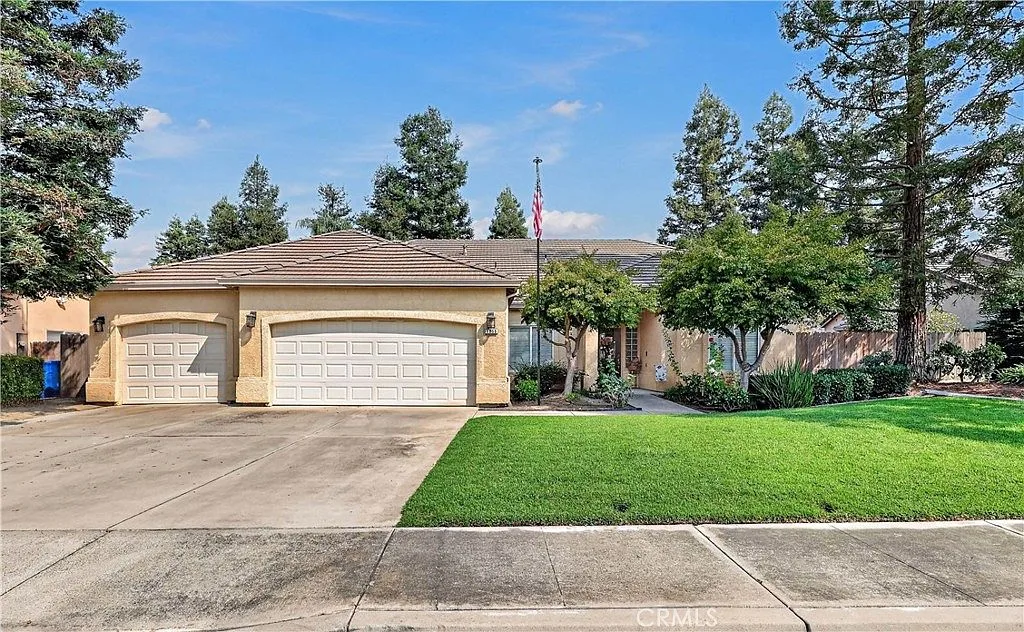 Curb appeal with mature trees and a wide driveway