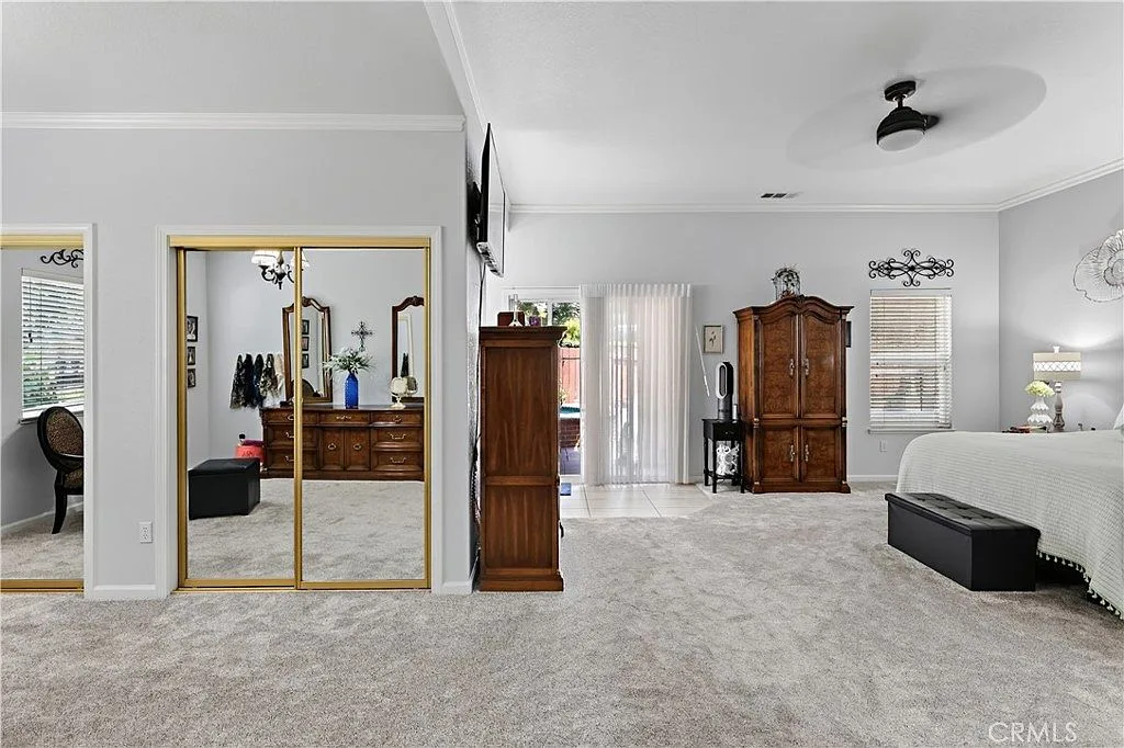 Primary bedroom suite at 1755 E Tuolumne Rd with sliding glass patio doors leading out toward the spa