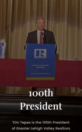 Tim Tepes speaking at an event podium