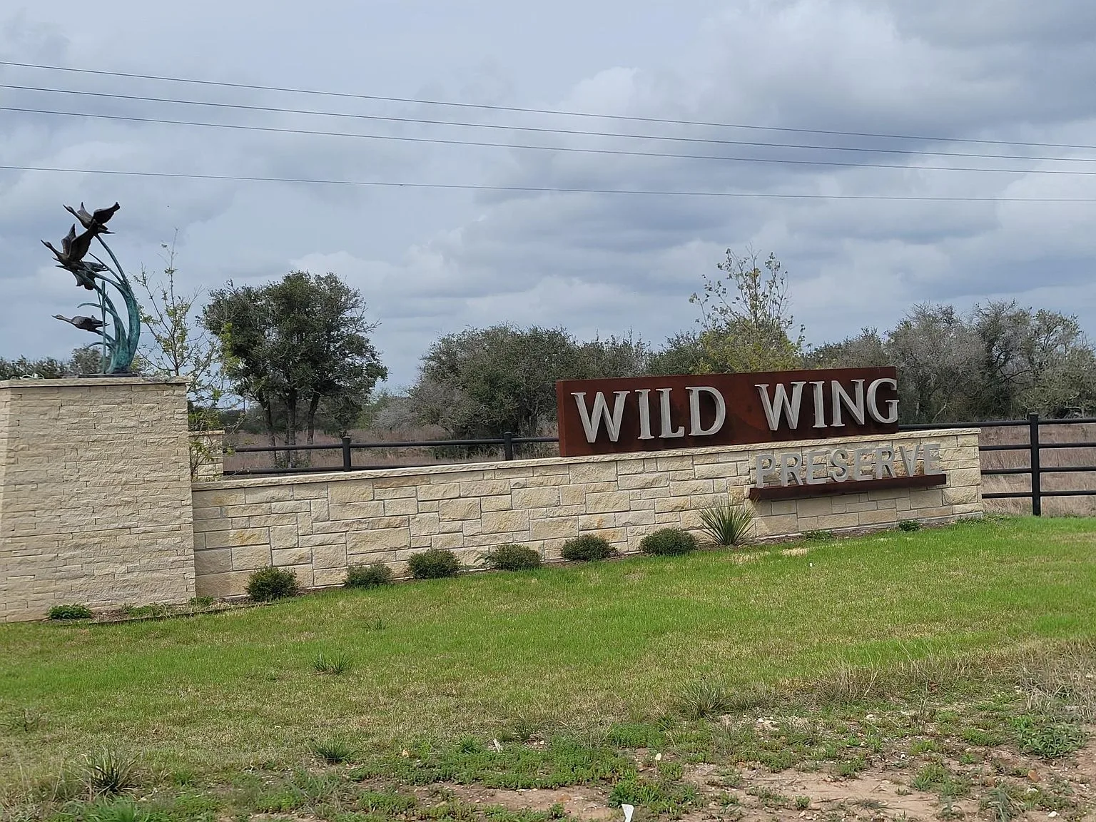 The stone entrance monument at Wild Wing Preserve