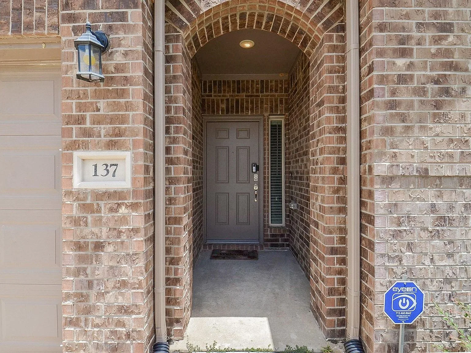 Recessed arched brick entryway of the home