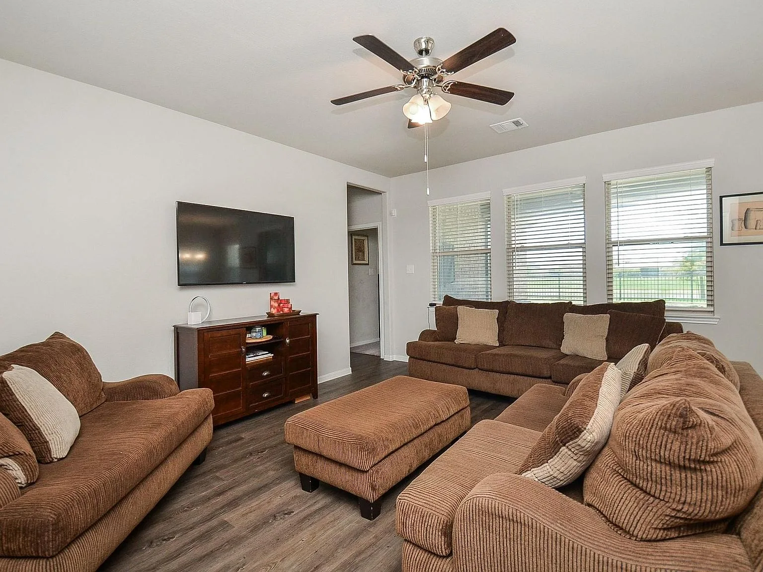 Living room with large windows and wood flooring