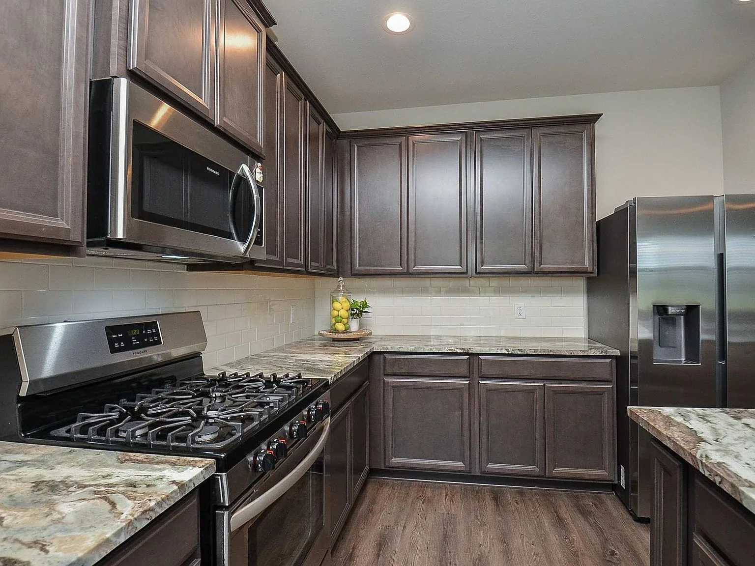 Kitchen with subway tile backsplash and stainless steel appliances