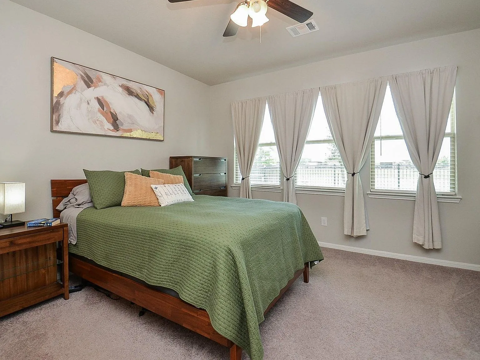 Secondary bedroom with carpet and neutral walls