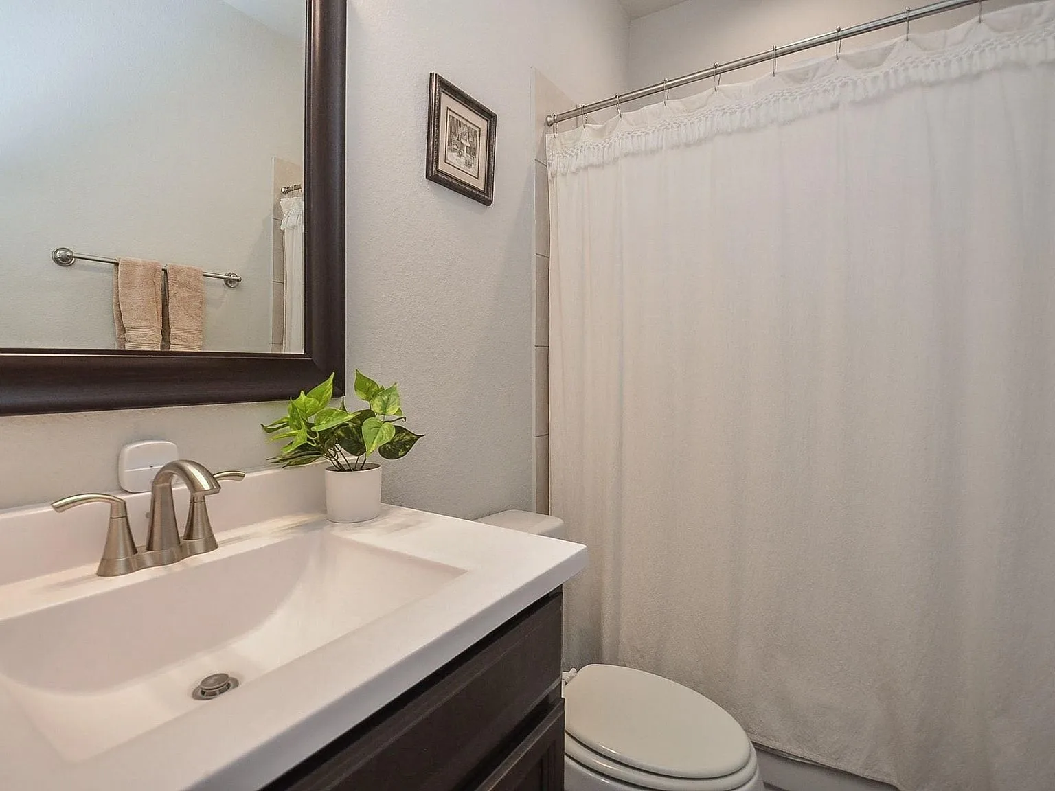 Guest bathroom with white vanity and shower