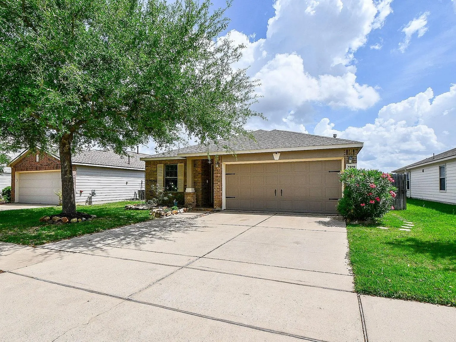 Front facade of the one-story brick and siding home at 2810 Roaring Oaks Ln in Katy, Texas