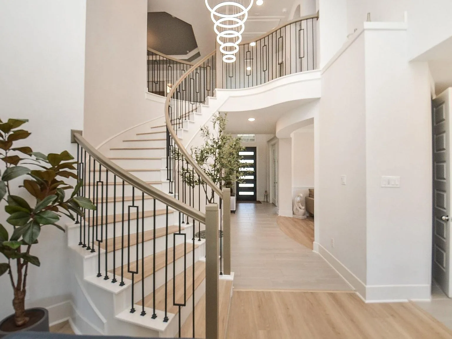 Two-story foyer with chandelier and staircase