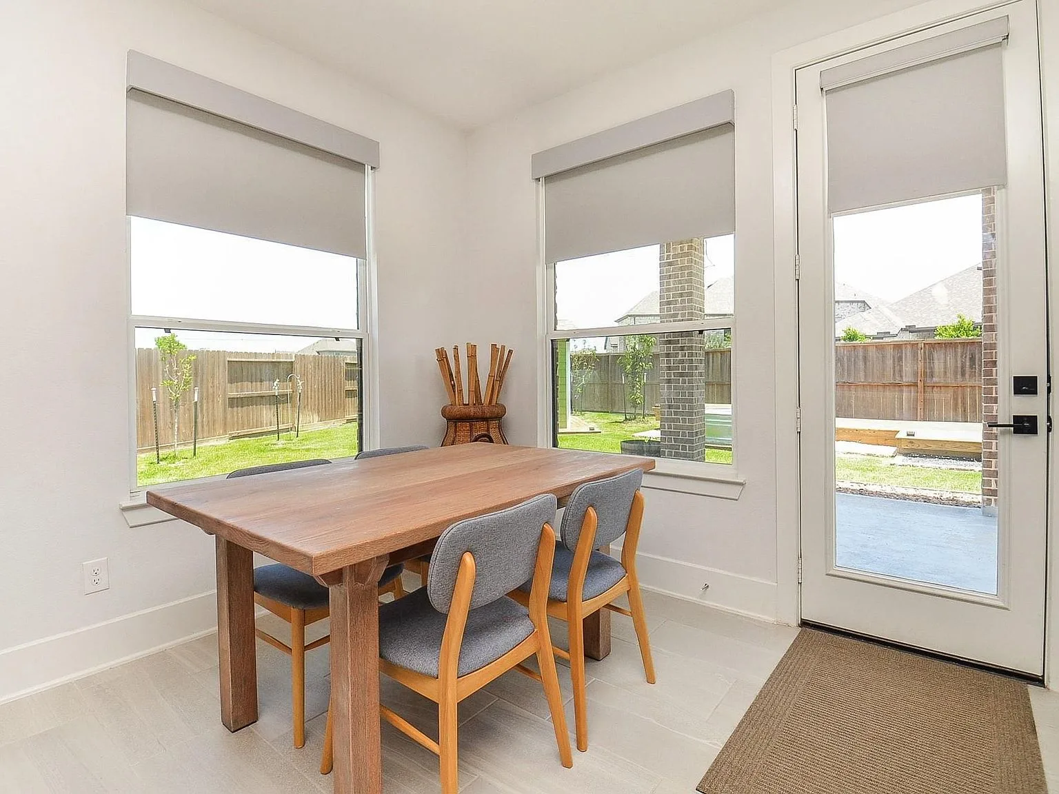 Bright breakfast nook off the kitchen with vinyl plank flooring