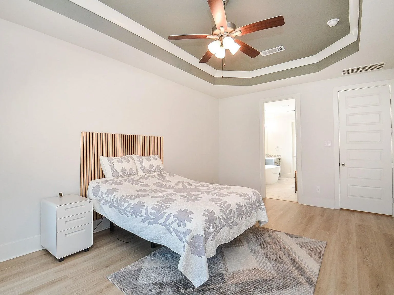 Master bedroom with acoustic slat wood headboard feature wall