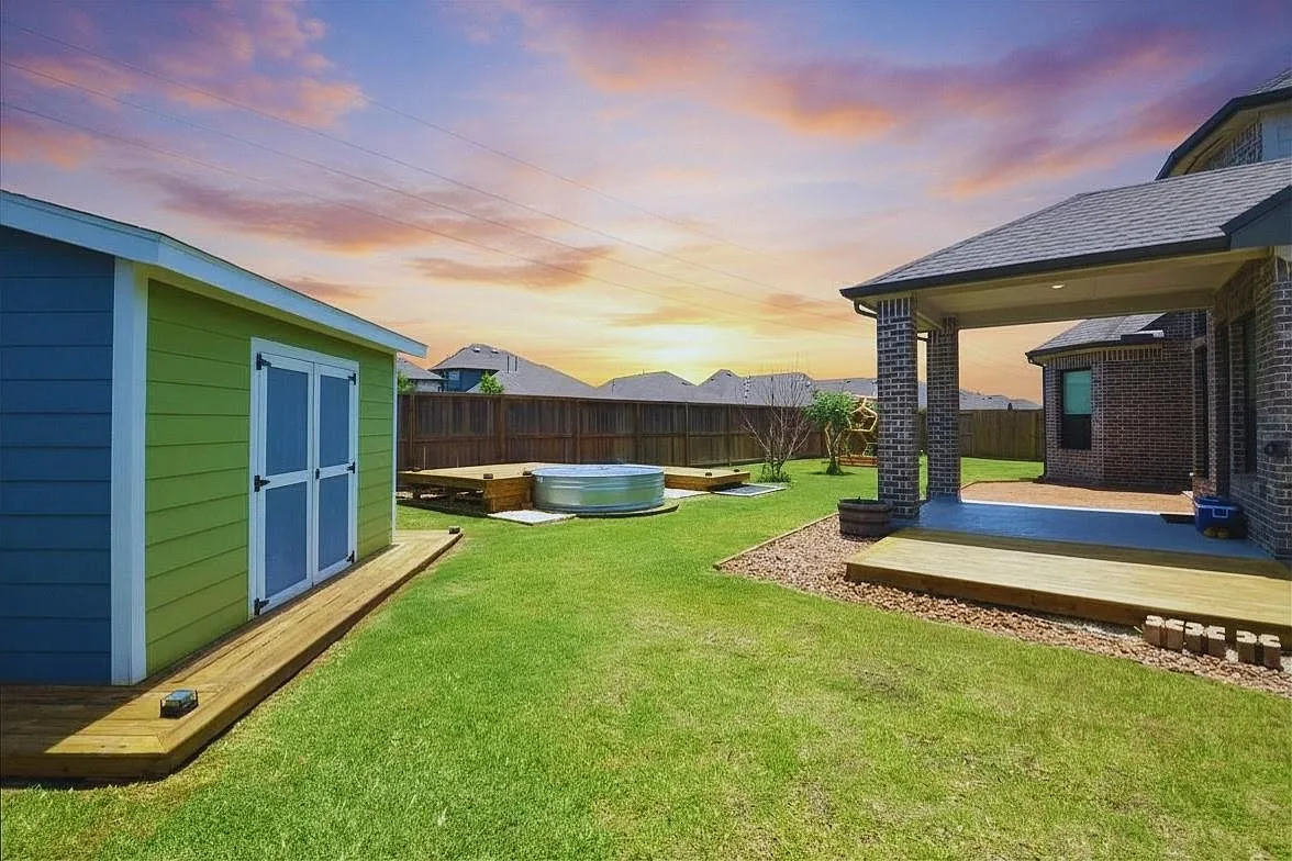 Covered patio, decking, and fruit trees at sunset