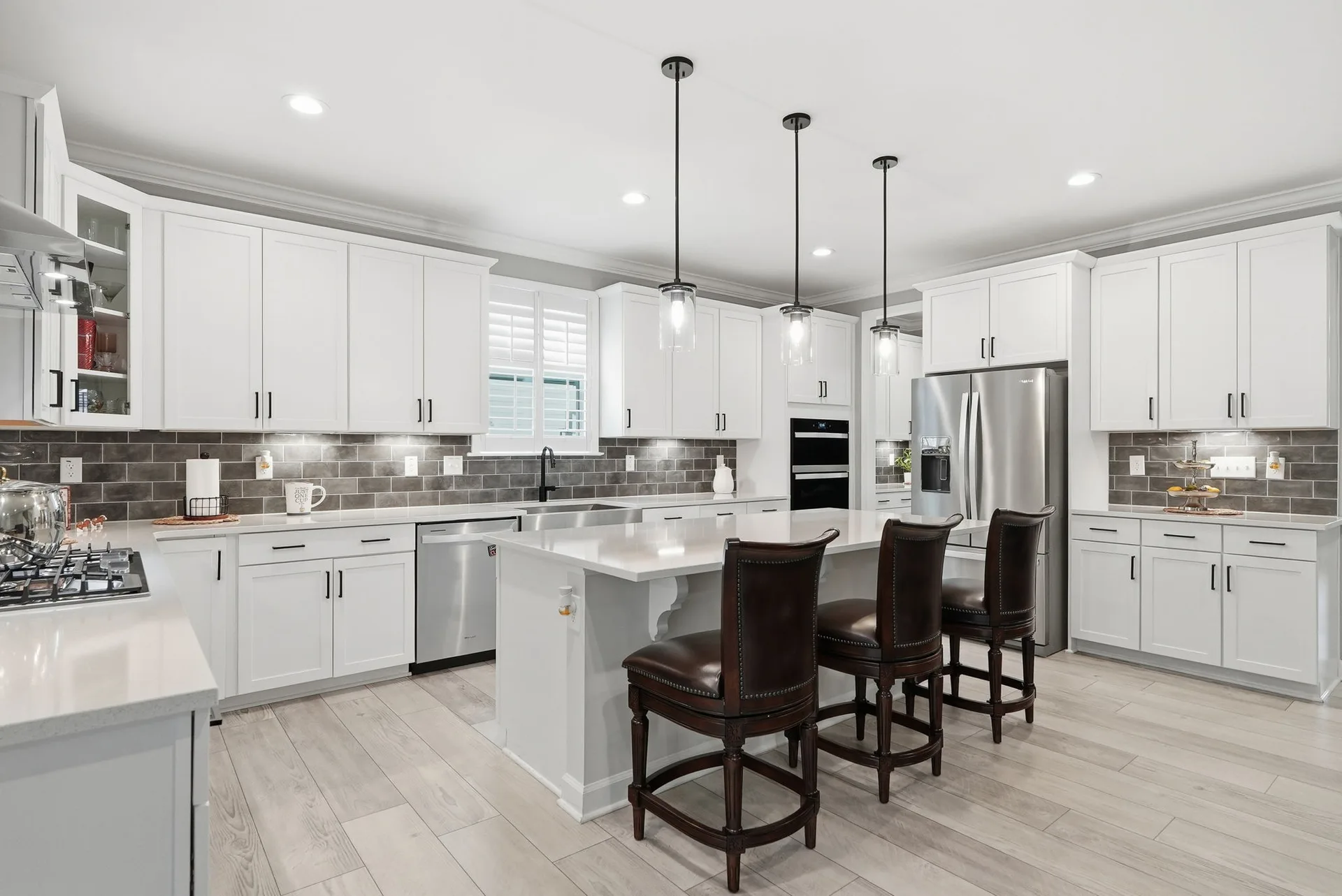 Kitchen with white cabinetry and a center island in a newer Clayton NC home