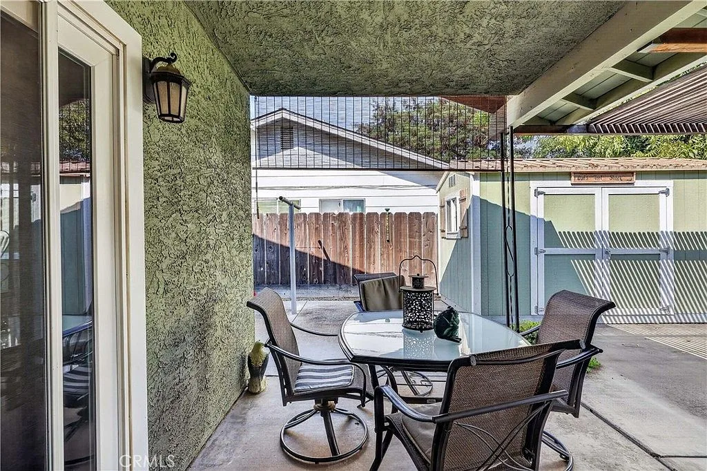 Large covered backyard patio with dining area