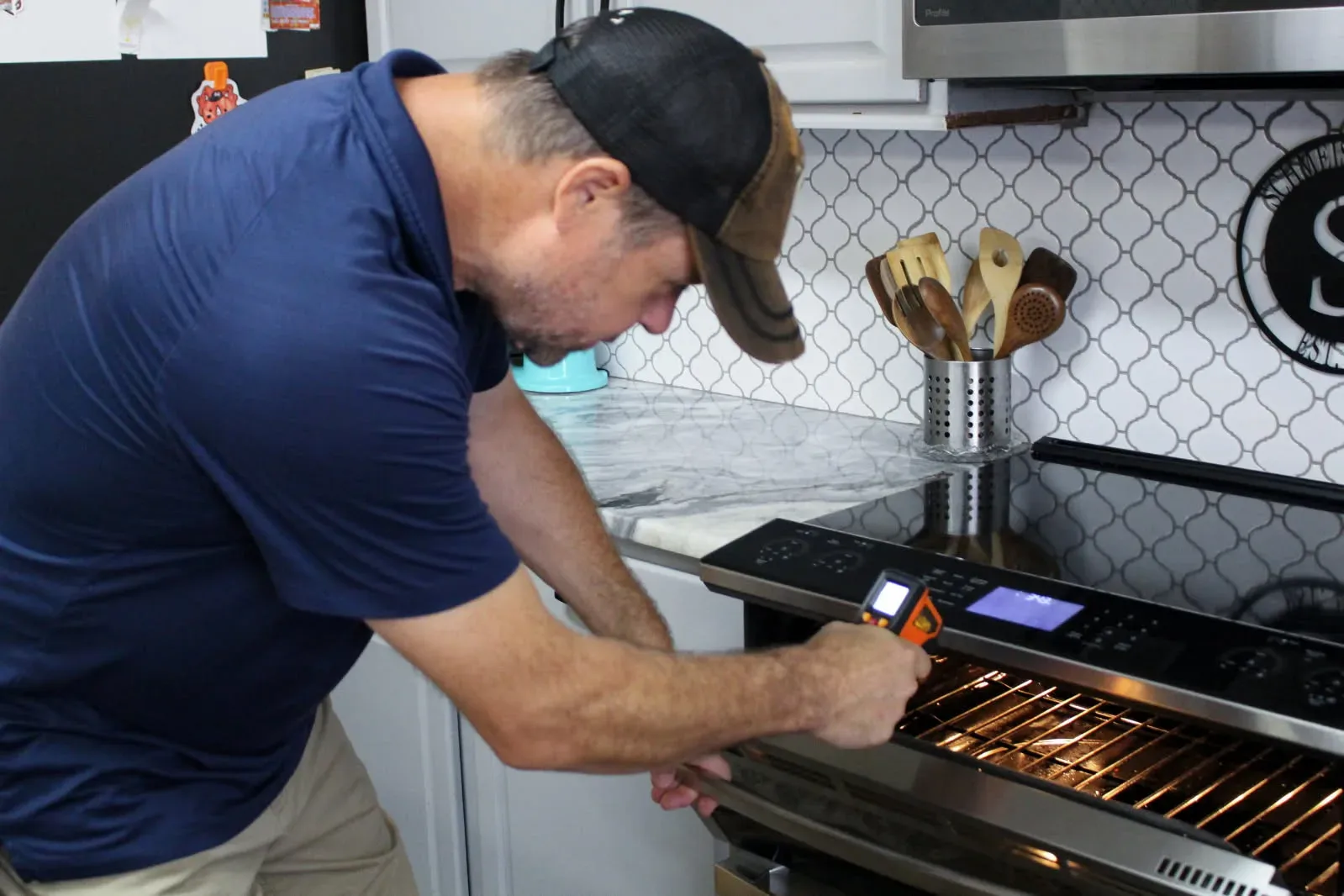 A Rodeo Home Inspections LLC inspector testing the oven during a kitchen inspection