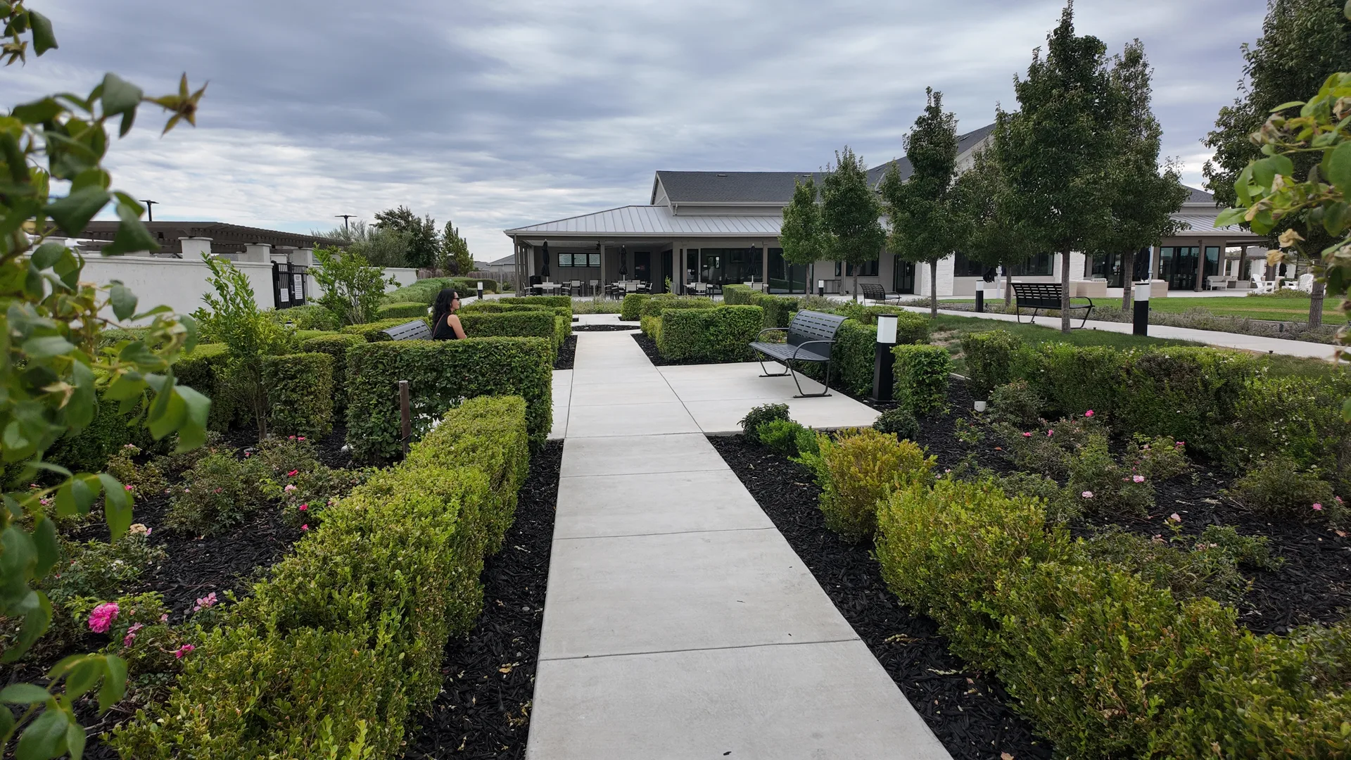 Courtyard and pedestrian walkway between homes in the gated Summit at Liberty 55+ community in Rio Vista, California, with low-maintenance landscaping