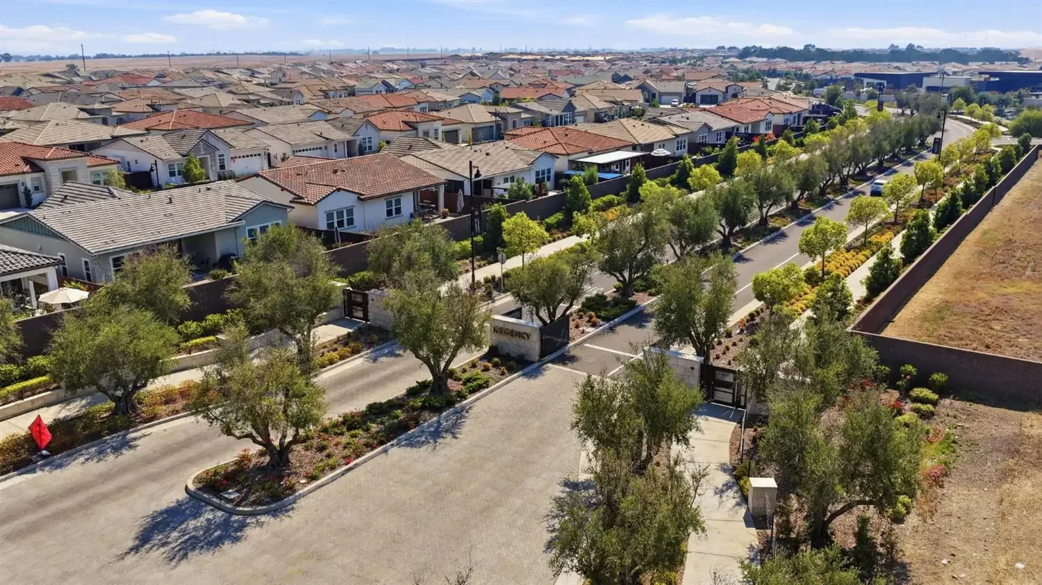 Aerial view of the gated community entrance at Regency at Folsom Ranch, the Toll Brothers 55+ community in Folsom, California