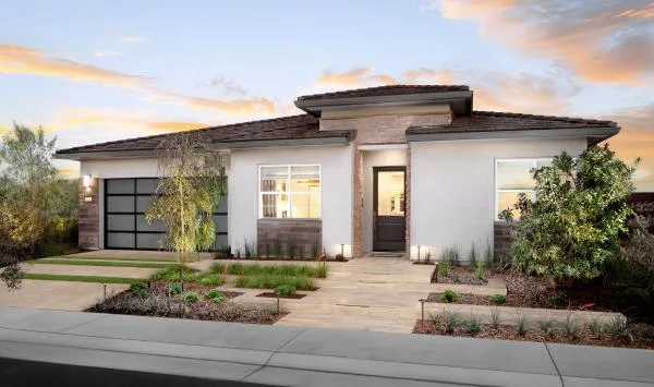 New-construction style stucco home exterior in a Northern California 55+ community; a recently built home in an active community can still be a resale
