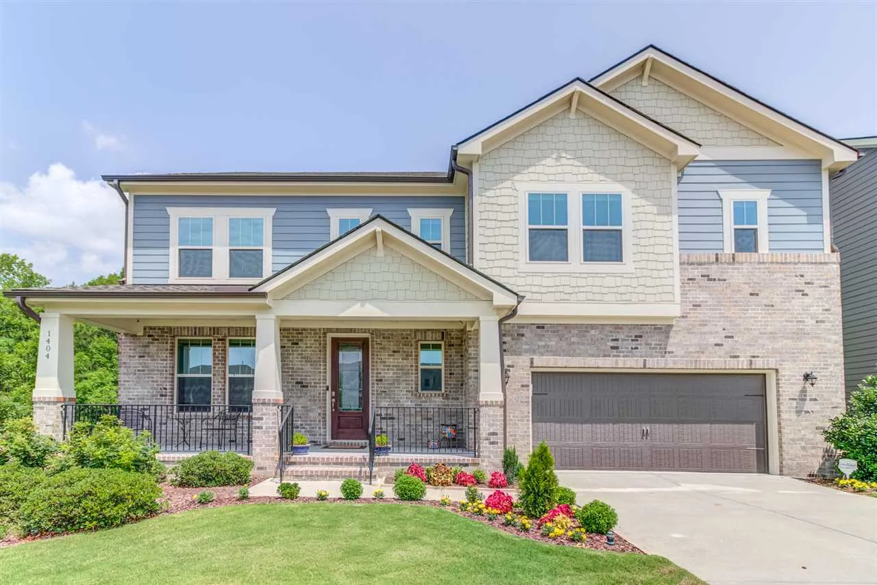 Modern suburban house with brick and siding, front porch, and landscaped yard in Southpoint, South Durham