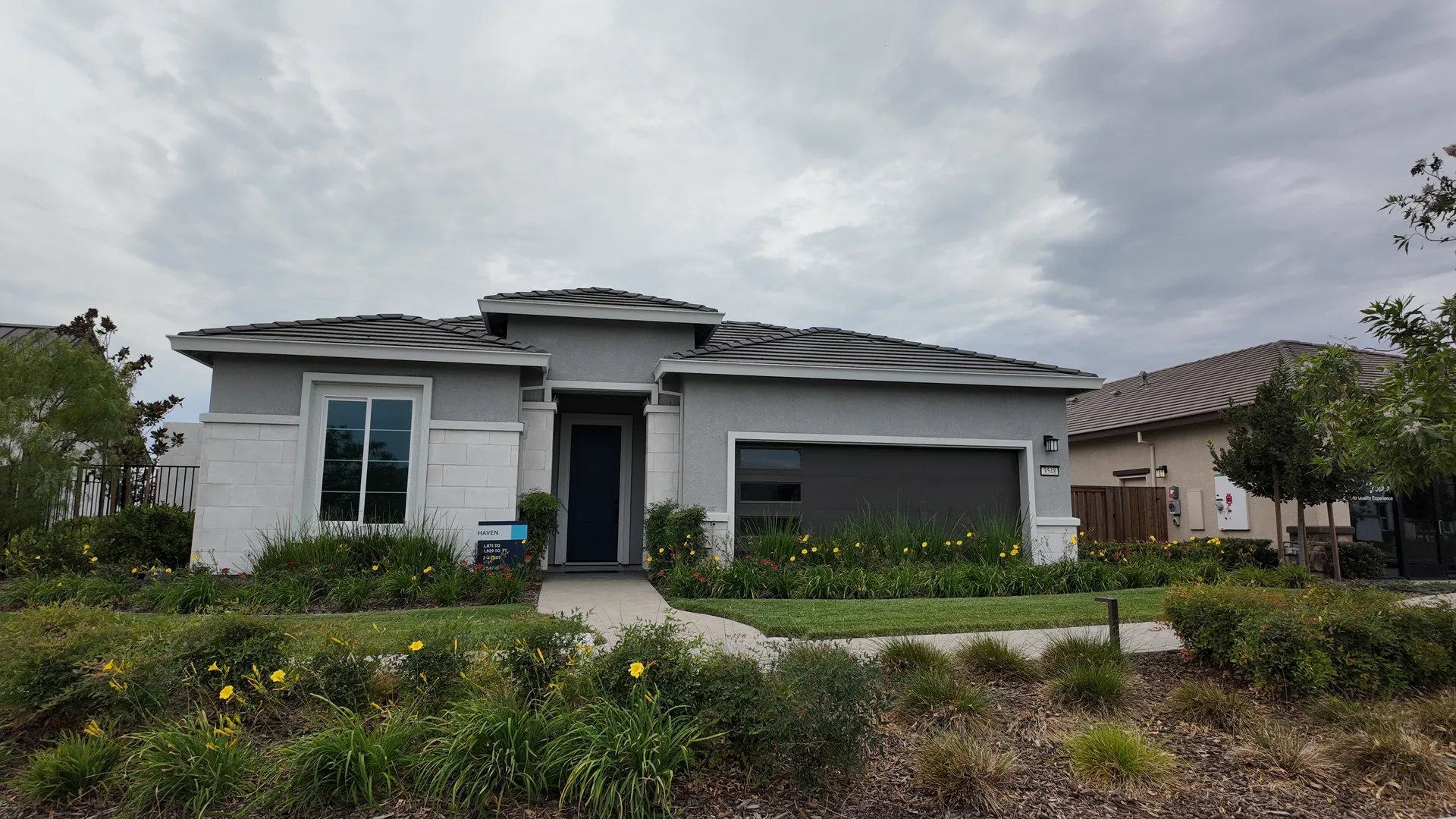 Aerial view of a modern single-story stucco home at Del Webb at River Islands in Lathrop, California, with a clean roofline and new-construction landscaping