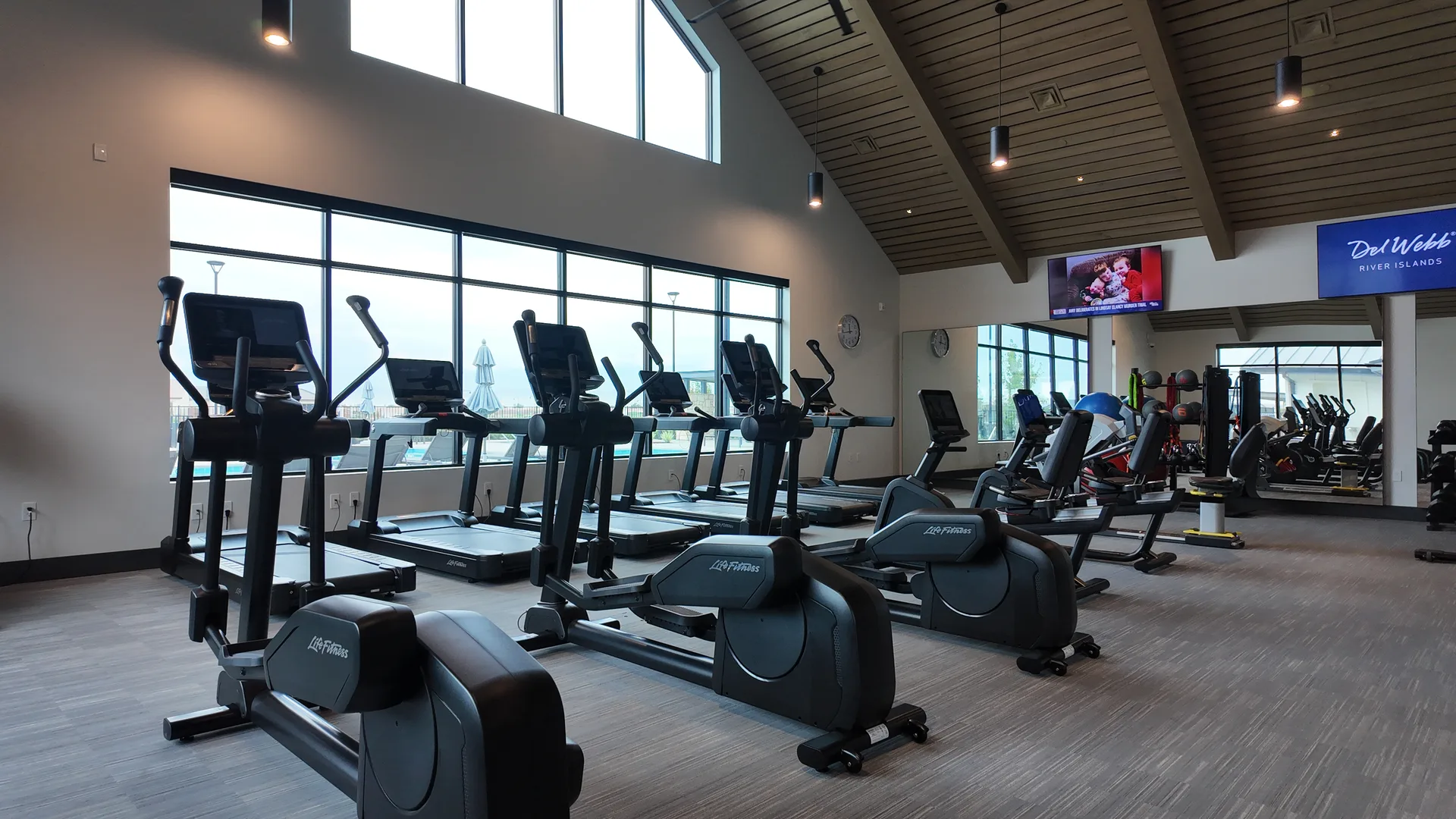 Fitness center at the Lakeview Club at Del Webb at River Islands in Lathrop, California, with cardio equipment, strength machines, dumbbells and open workout space