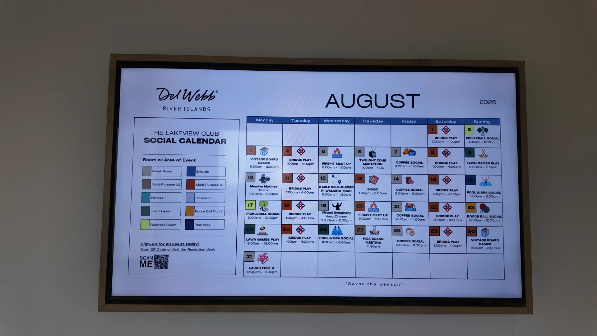 The August 2026 Lakeview Club social calendar at Del Webb at River Islands in Lathrop, California, photographed on the wall and showing daily classes, games and social events