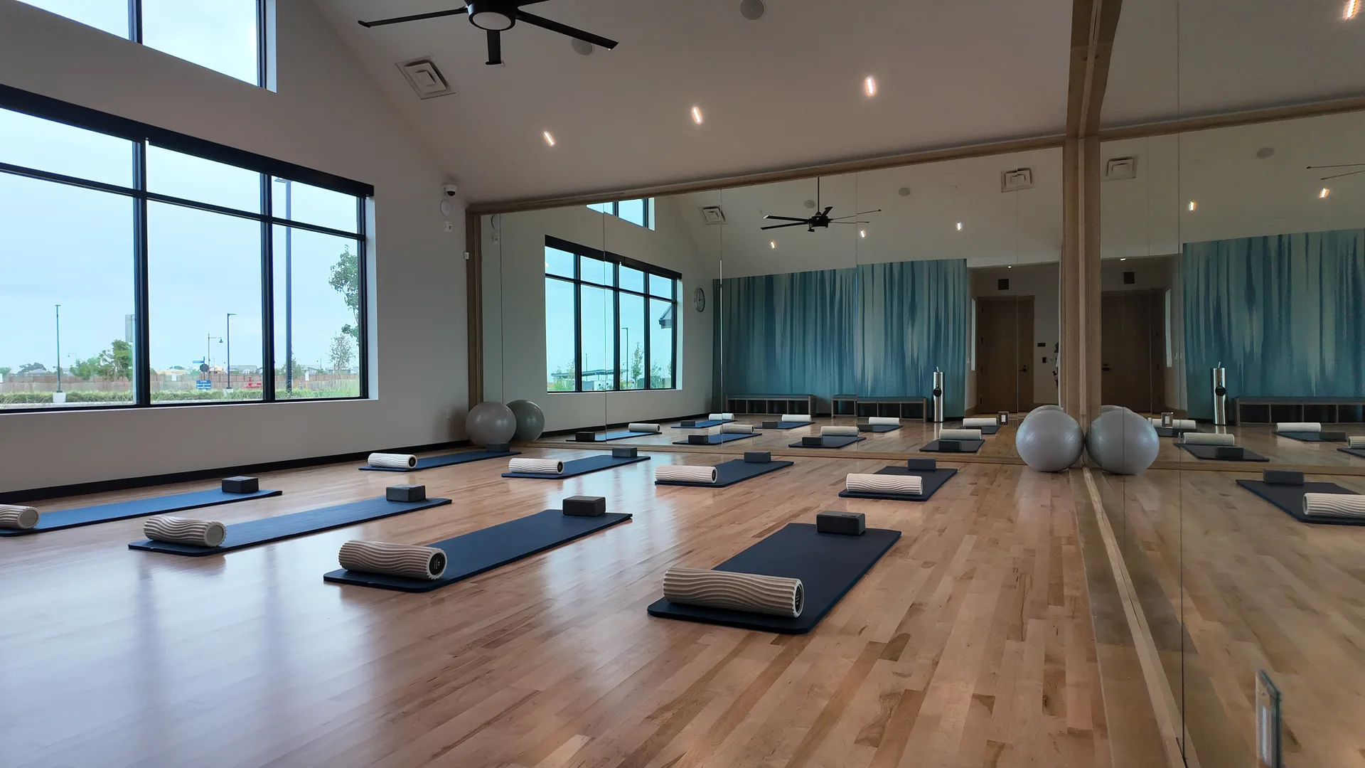 Mirrored group-exercise studio at the Lakeview Club at Del Webb at River Islands in Lathrop, California, photographed from a different angle with the open floor and mirrored walls
