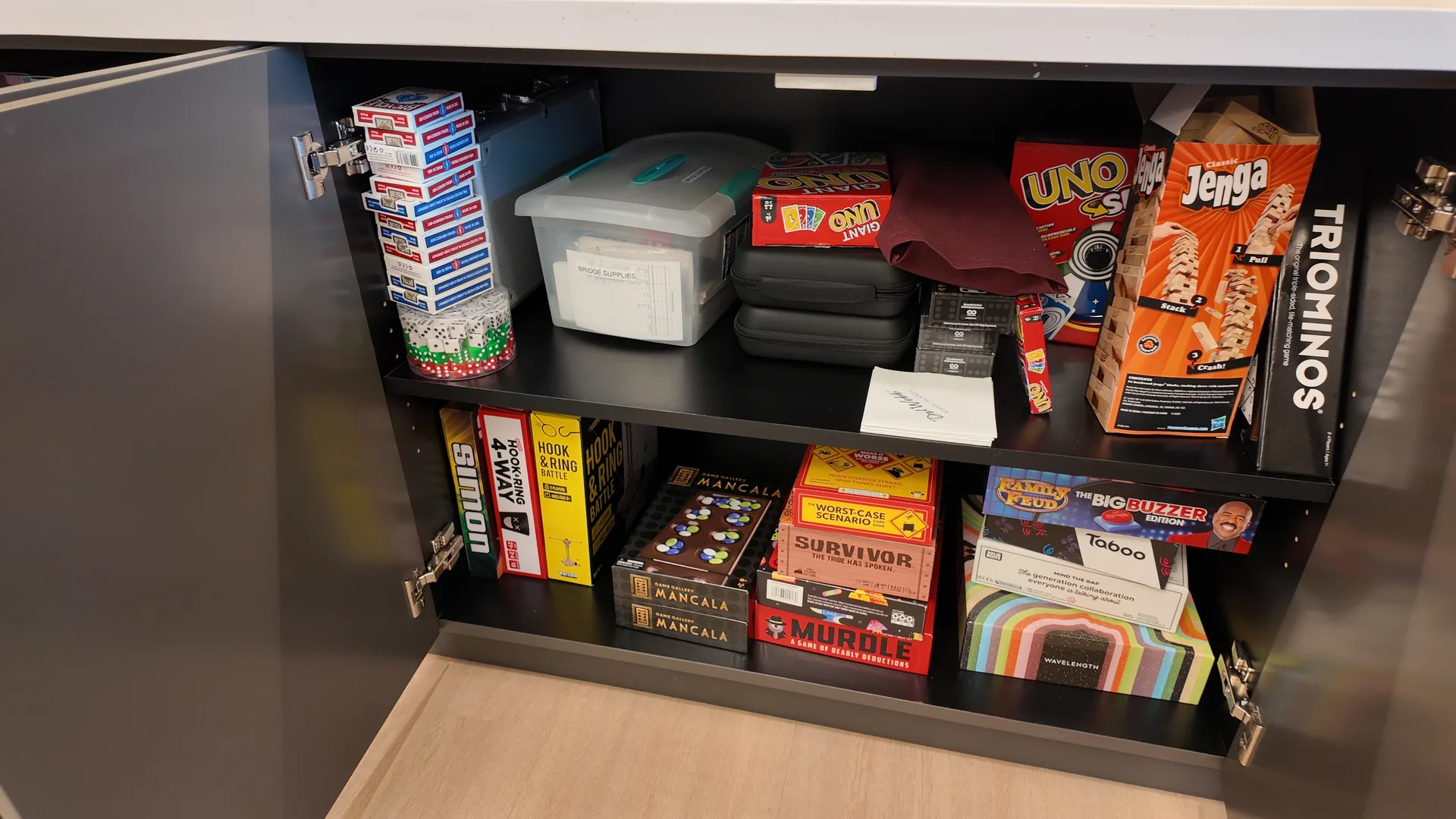 Stocked activity cabinets inside Multipurpose Room 3 at the Lakeview Club at Del Webb at River Islands in Lathrop, California, with games, puzzles, bingo supplies, books and craft materials on the shelves
