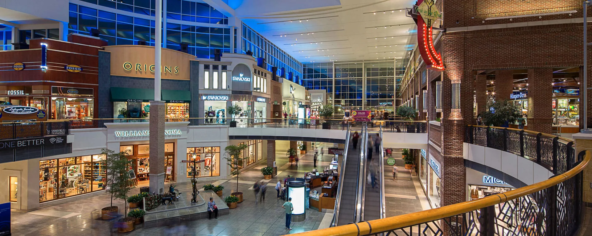 The two-level interior concourse of The Streets at Southpoint, with storefronts and skylights, in South Durham