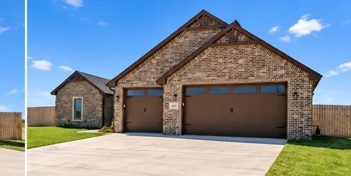 Front view of the brown brick facade with gabled roof and dark brown garage doors