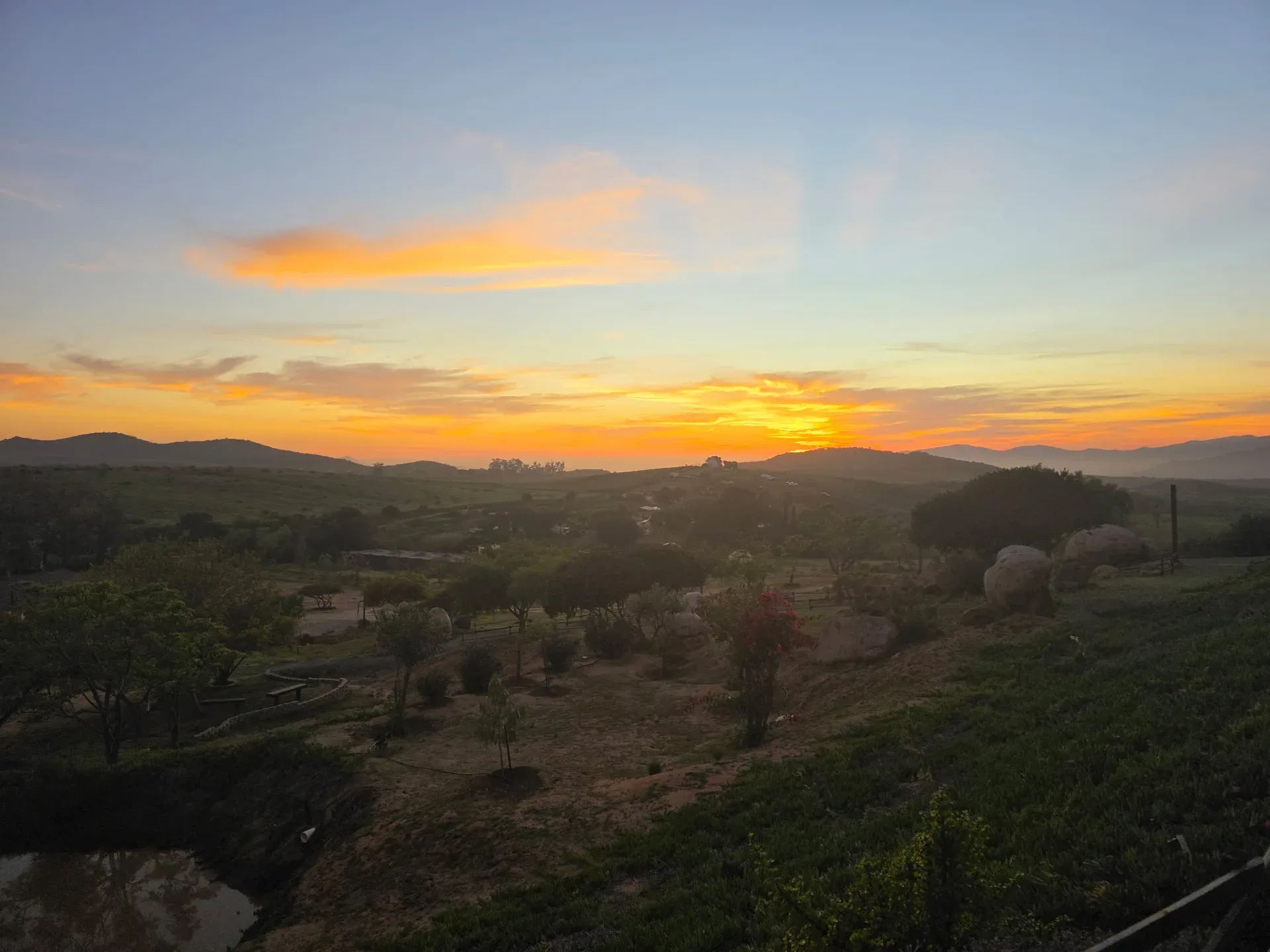 Sunset light over the rolling hills of Rancho El Refugio, the partner ranch near Ensenada, Mexico, where mission teams stay