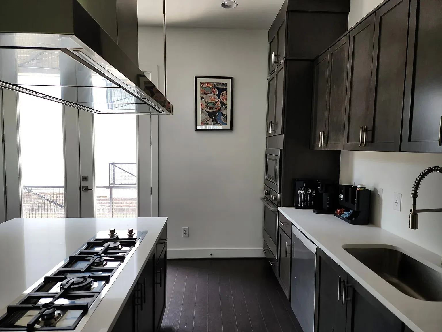 Modern kitchen with dark cabinets and quartz counters