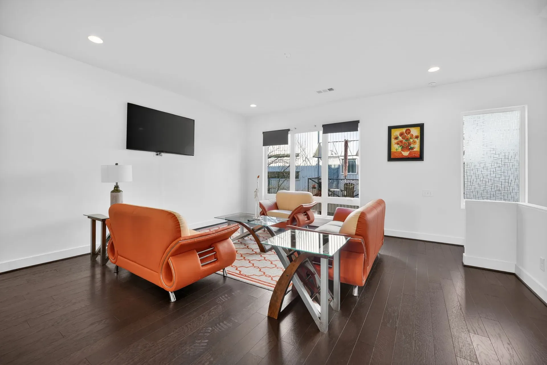 Bright open living room with large windows at 241 Maynard Terrace