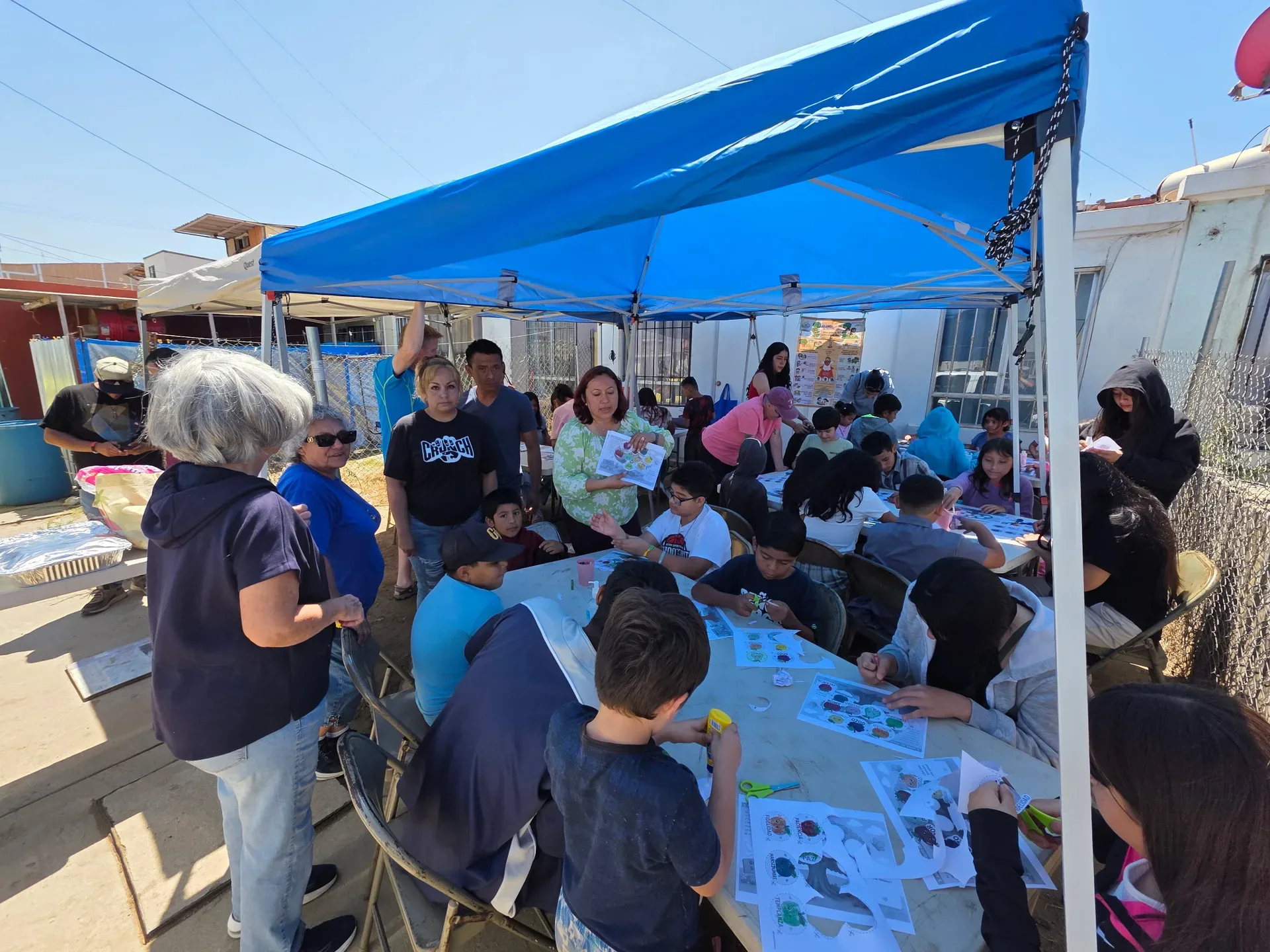 Ensenada Ministries team sharing the gospel with kids during outdoor community outreach