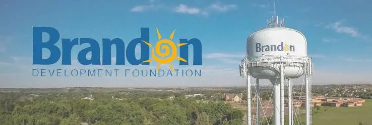 Aerial view of Brandon with the water tower and the Brandon Development Foundation brand graphic overlay