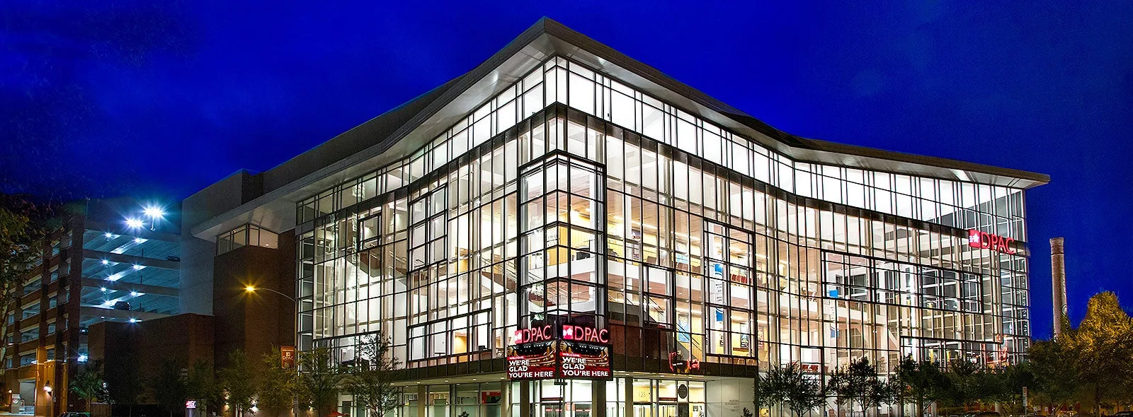 Durham Performing Arts Center (DPAC) exterior lit up at night in downtown Durham, about a mile from Trinity Park