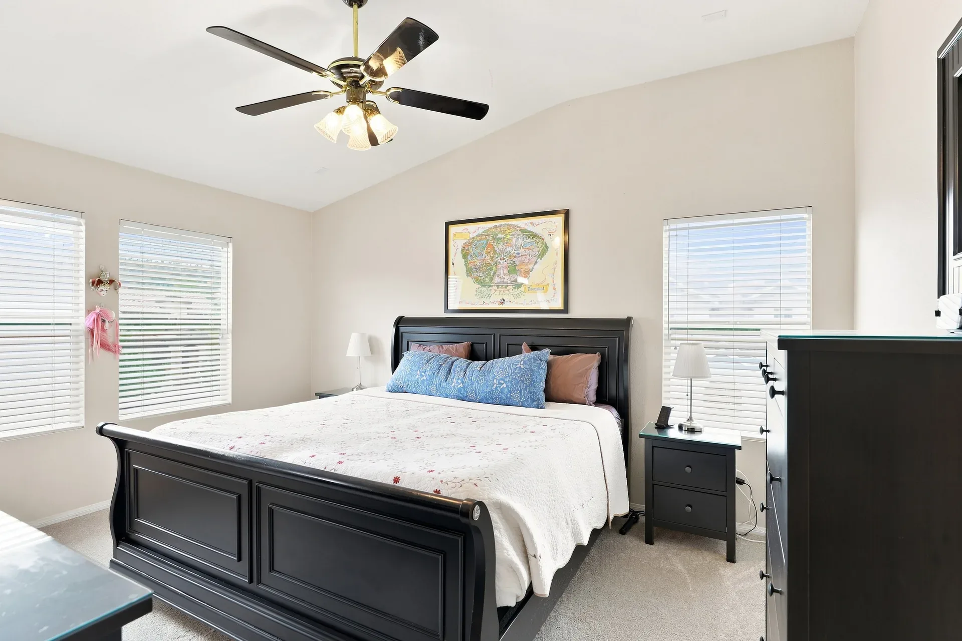 Primary bedroom with neutral finishes and abundant natural light