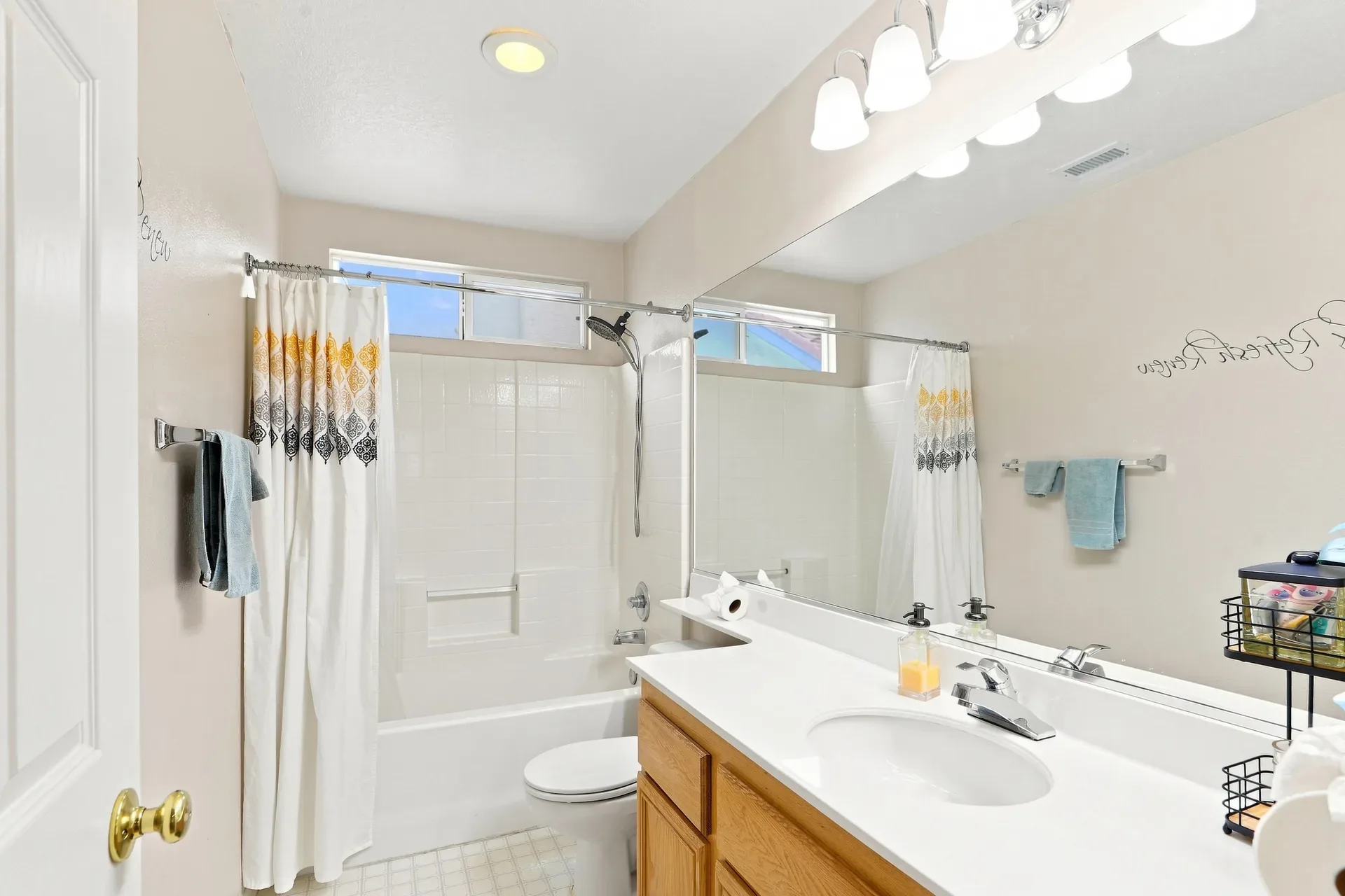 Bathroom with oak vanity and white shower surround