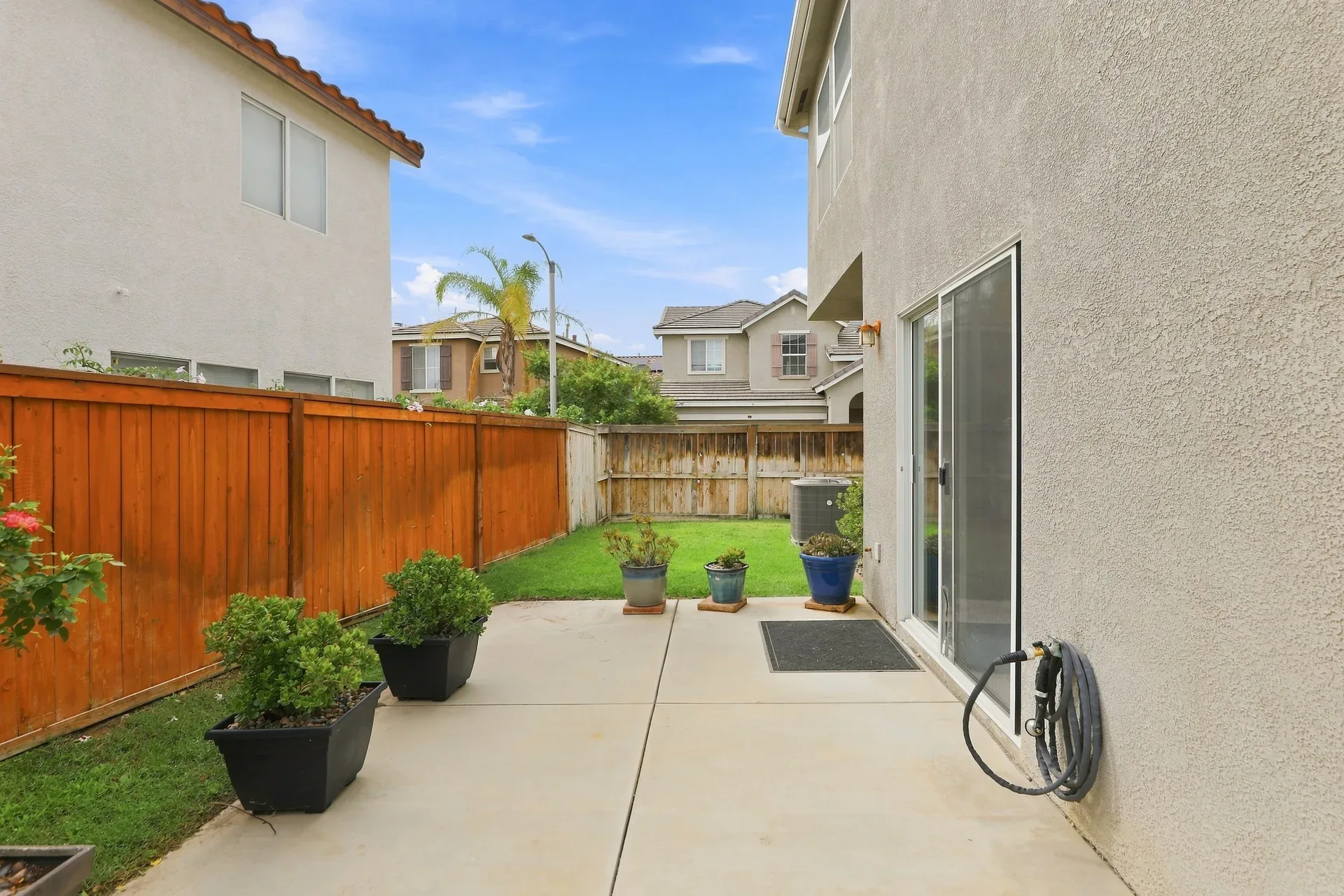 Backyard concrete patio along the house