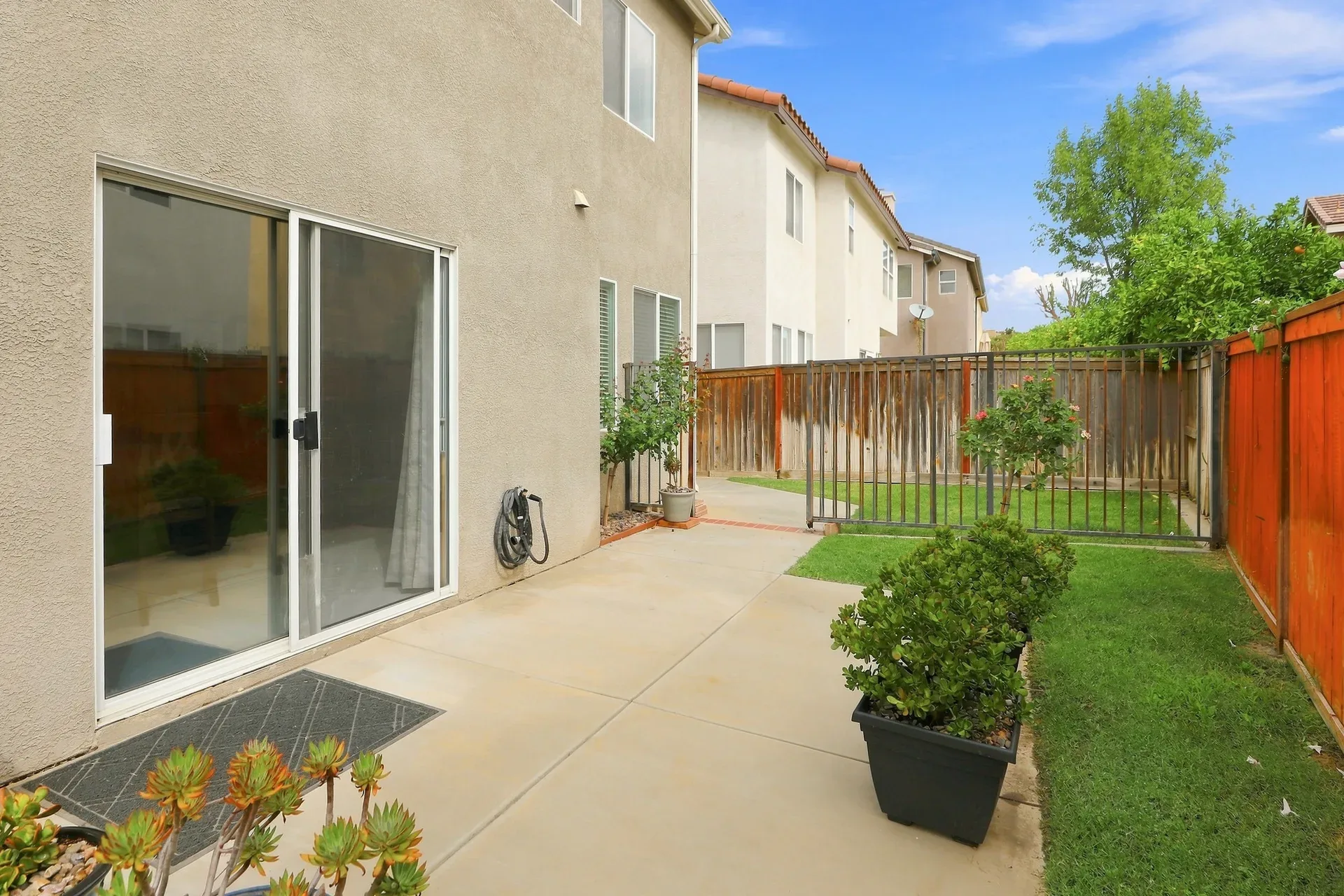 Backyard patio with sliding glass door access