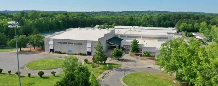 Aerial view of a school campus with brick buildings serving the Croasdaile, Durham area