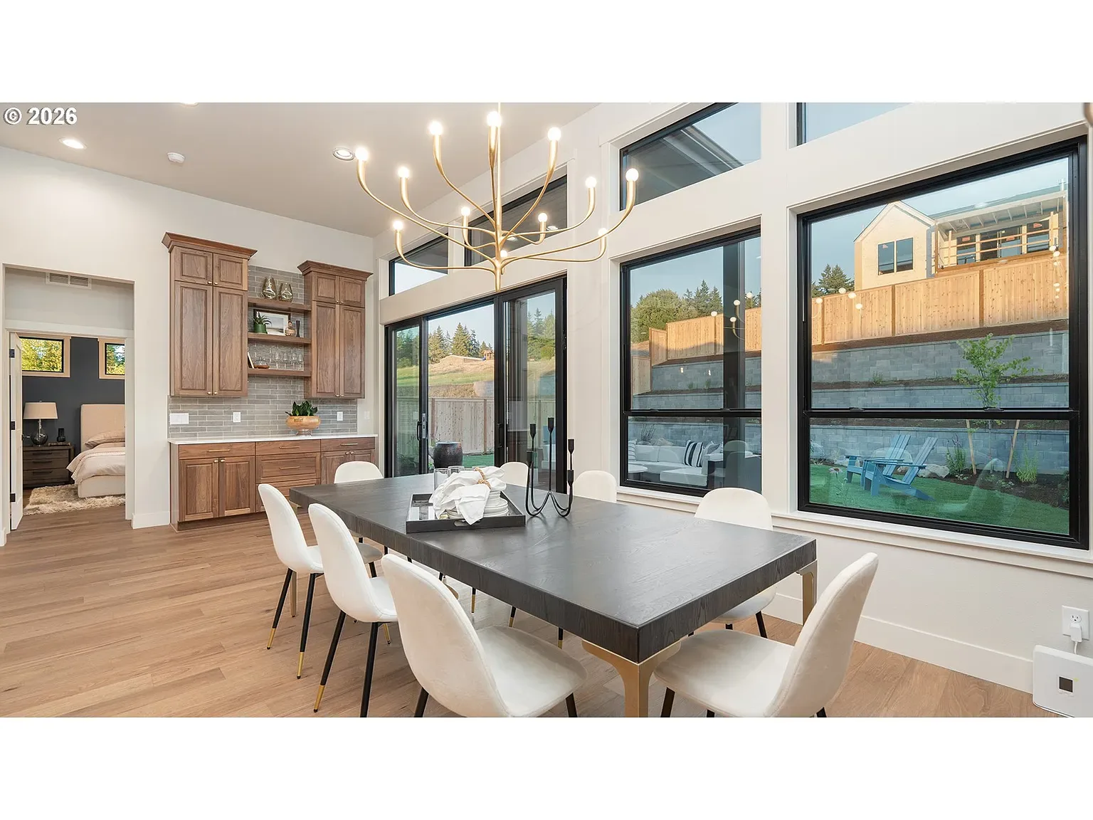 Dining: Floor-to-ceiling windows and a sculptural branch chandelier