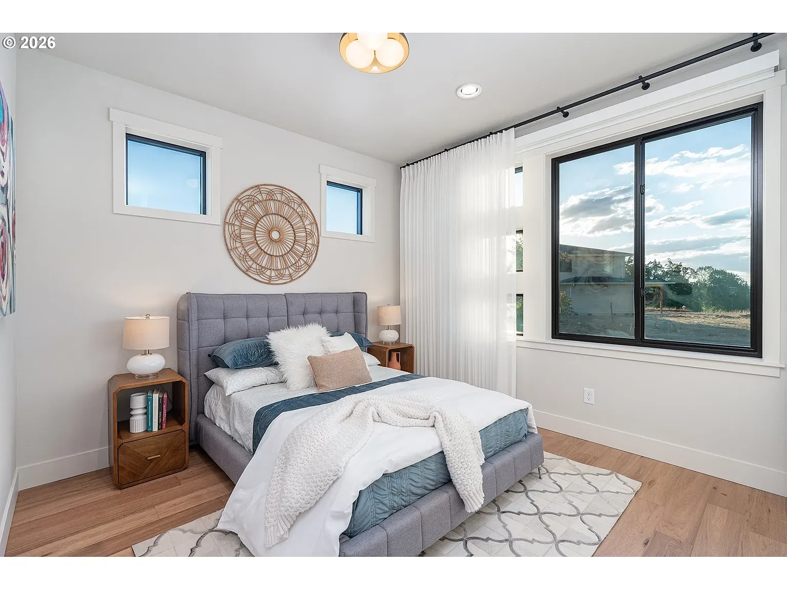 Bedroom suite: Black-framed windows and a calm, airy palette