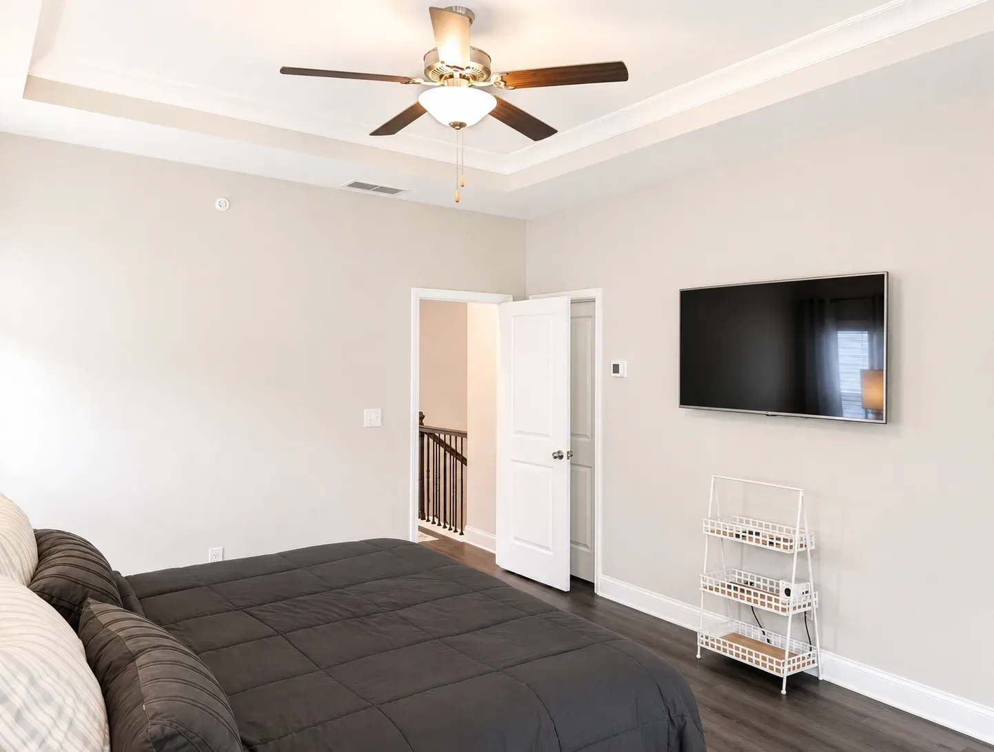 Bedroom with tray ceiling and neutral paint