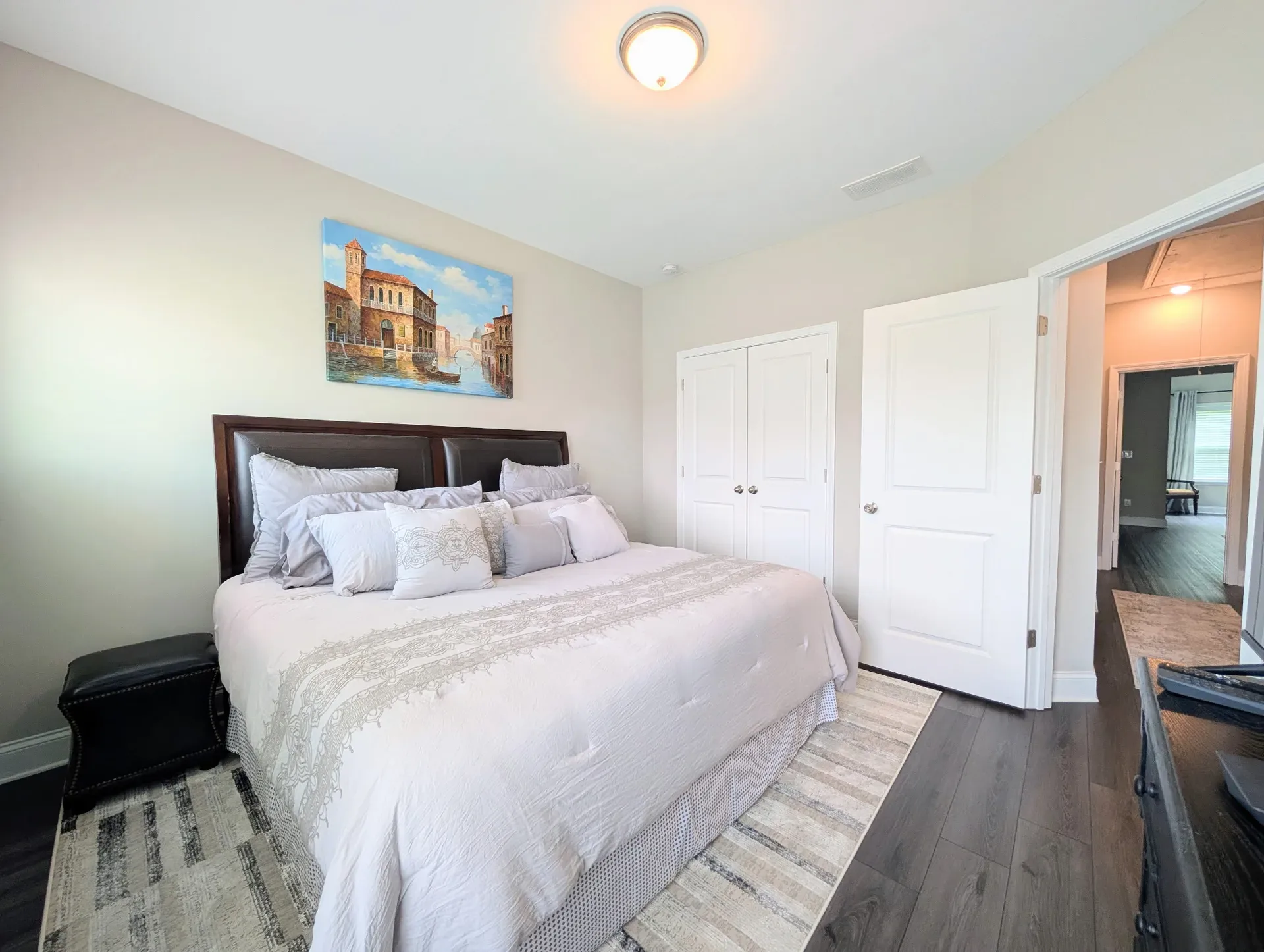 Primary bedroom with daylight and neutral decor