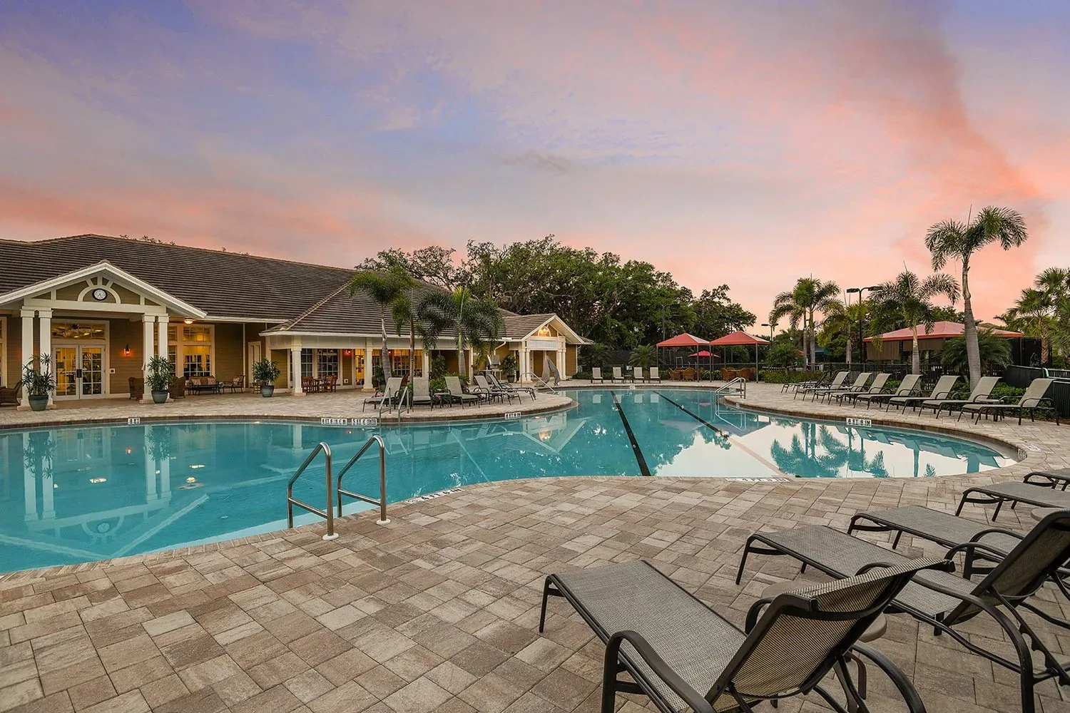 Community pool and clubhouse deck at a Southwest Florida new construction community