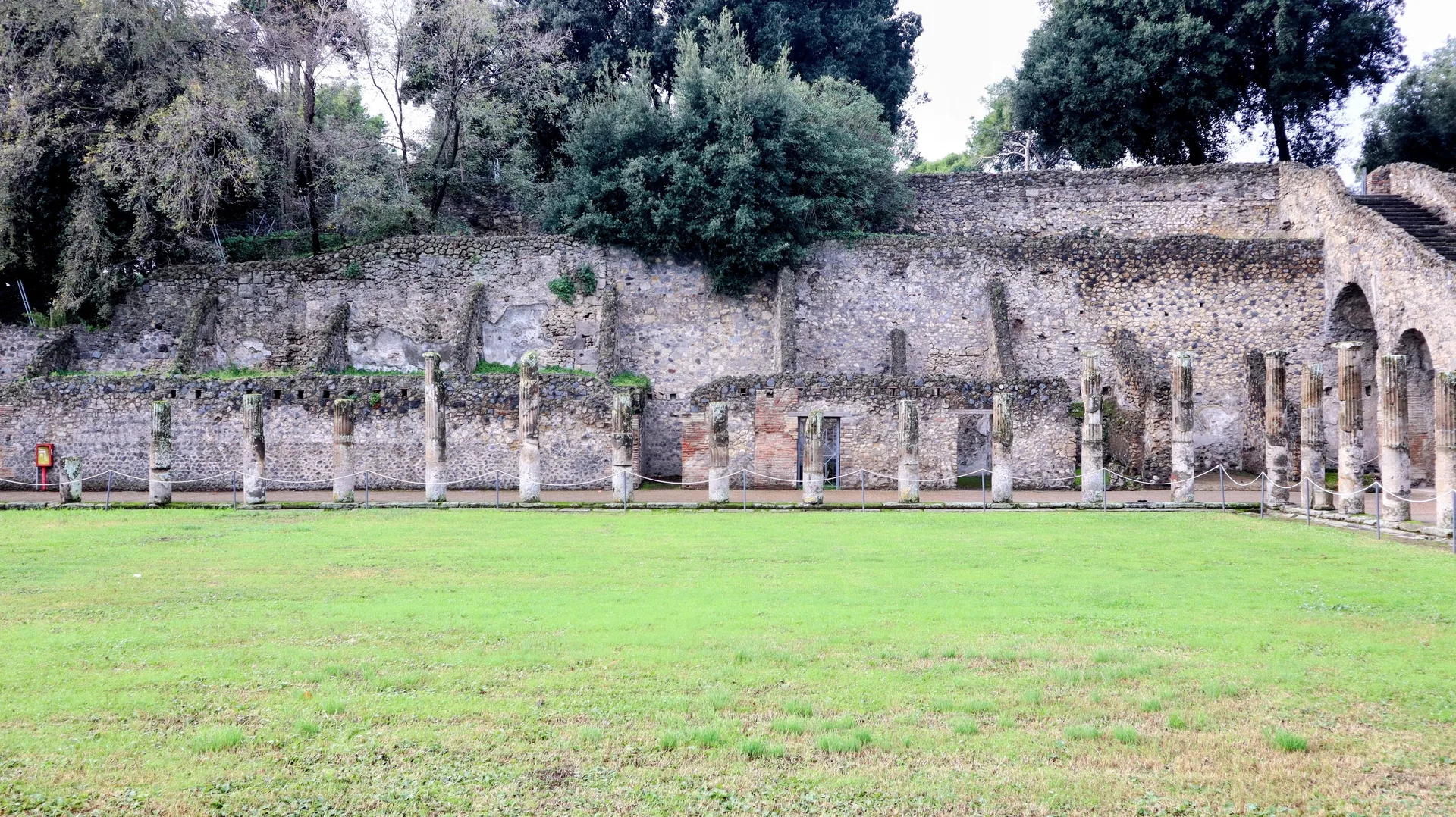 Roman columns and open ground among the ruins of Pompeii