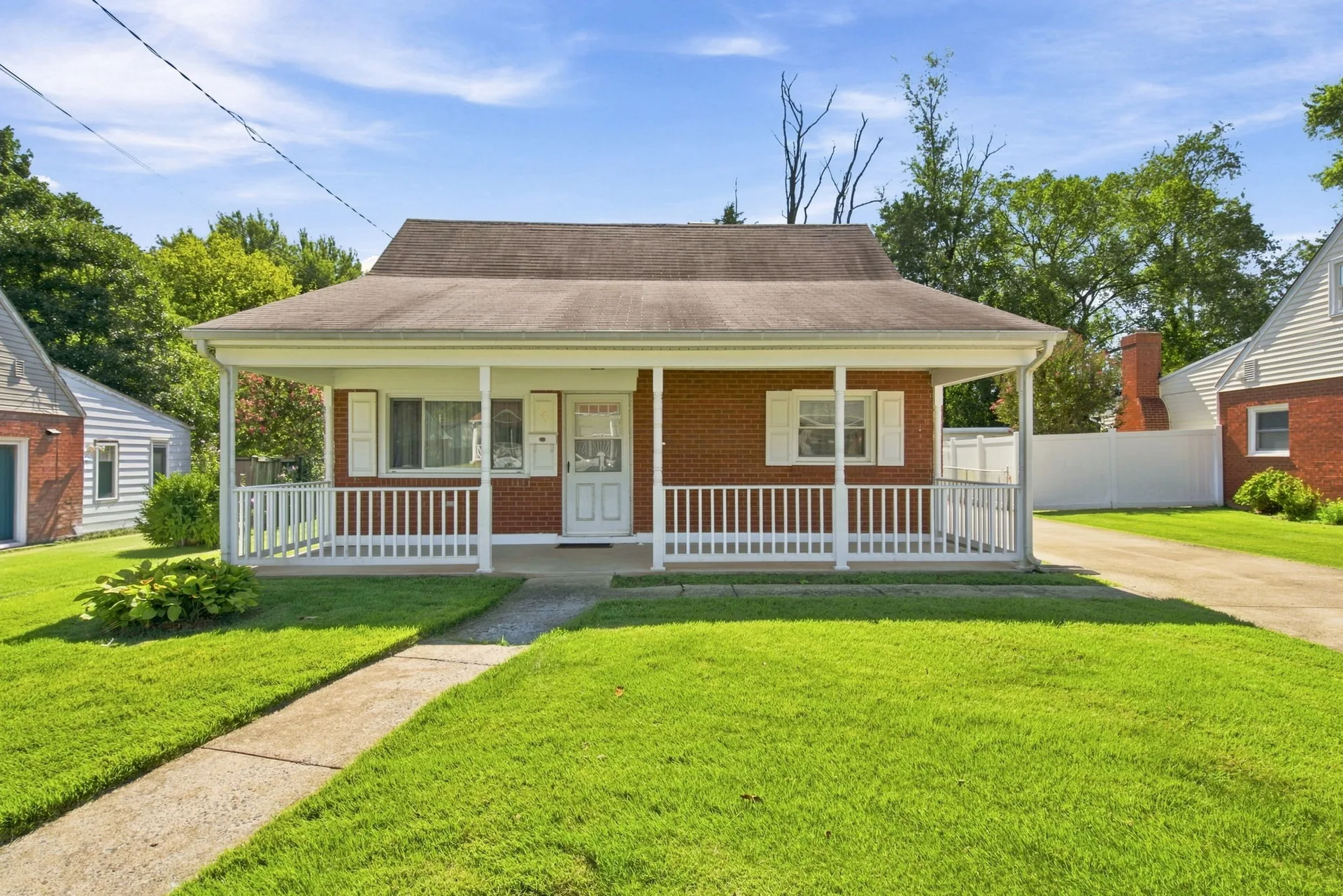 Front exterior of 179 Colburn Drive, a brick and white siding single-family home with a covered front porch in Manassas Park, VA