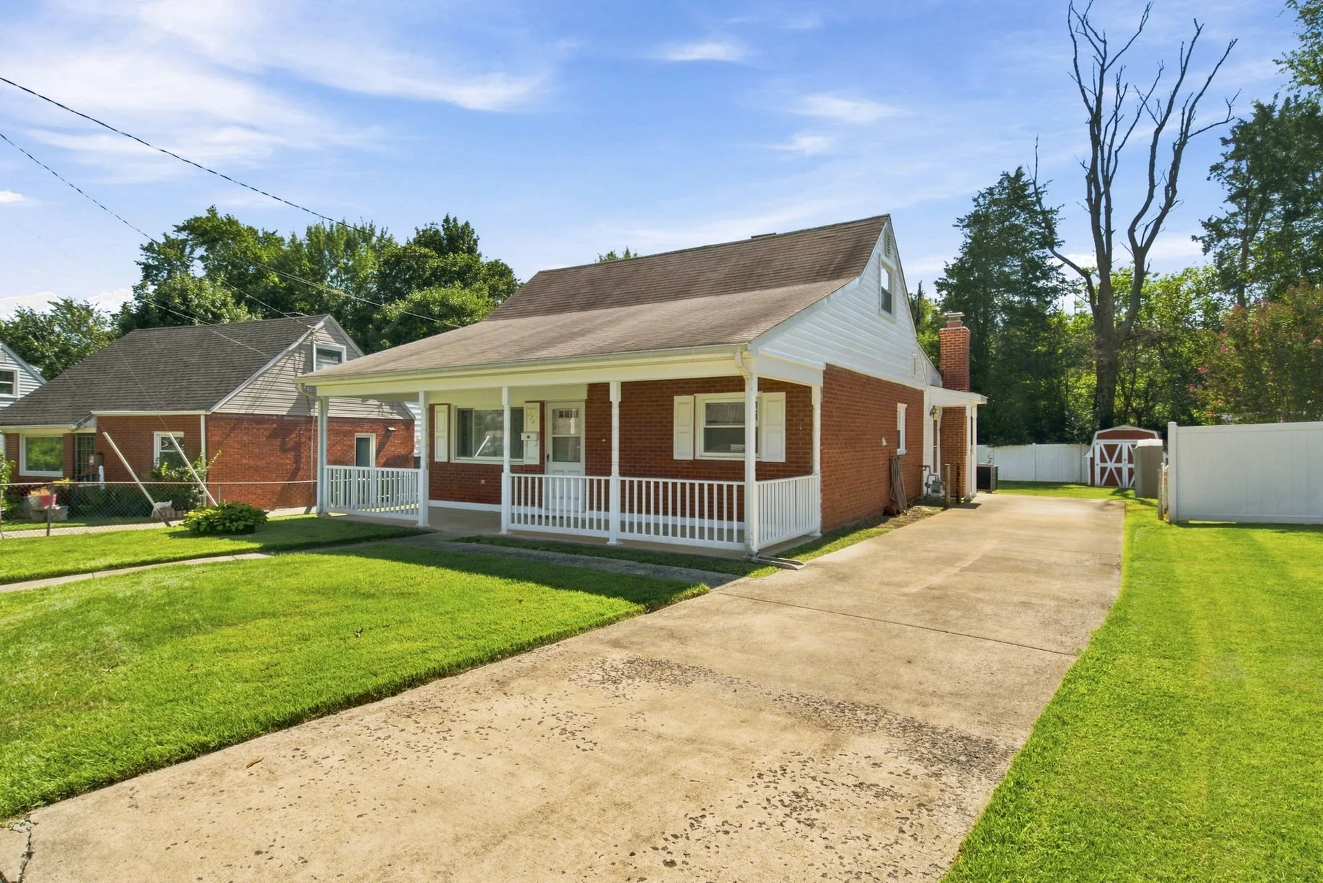 Angled street-level view of the home with concrete driveway and lawn