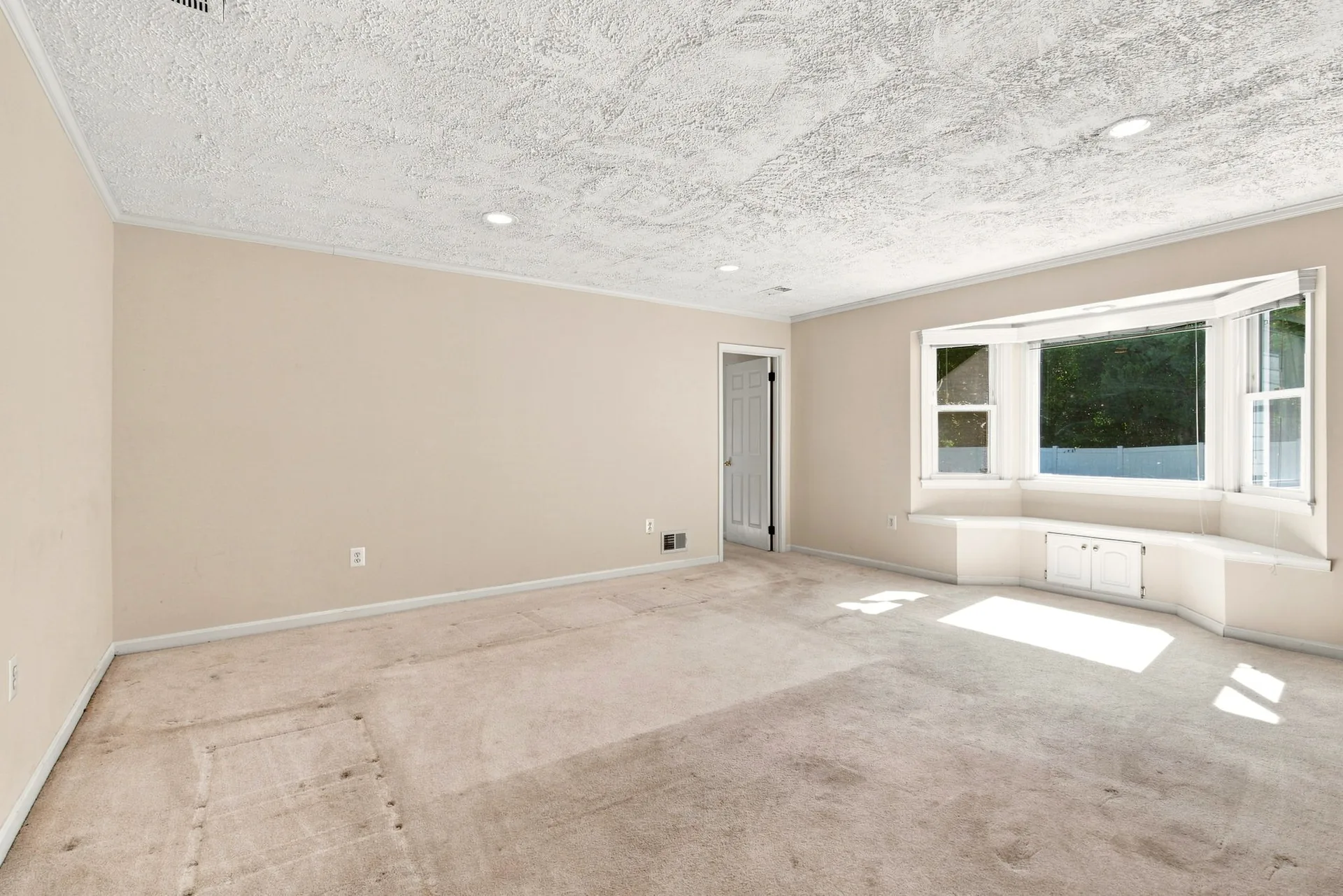 Living room bay window with built-in bench seating and storage below