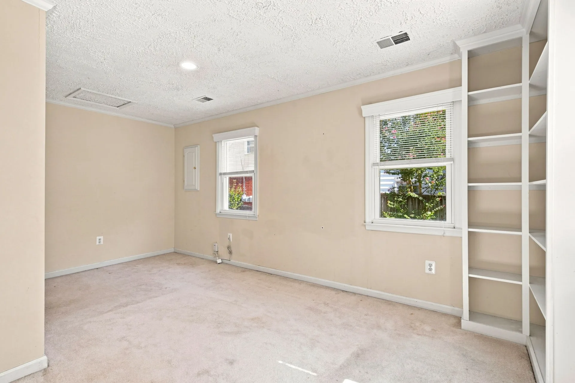 Bedroom with white trim and a built-in white shelving unit
