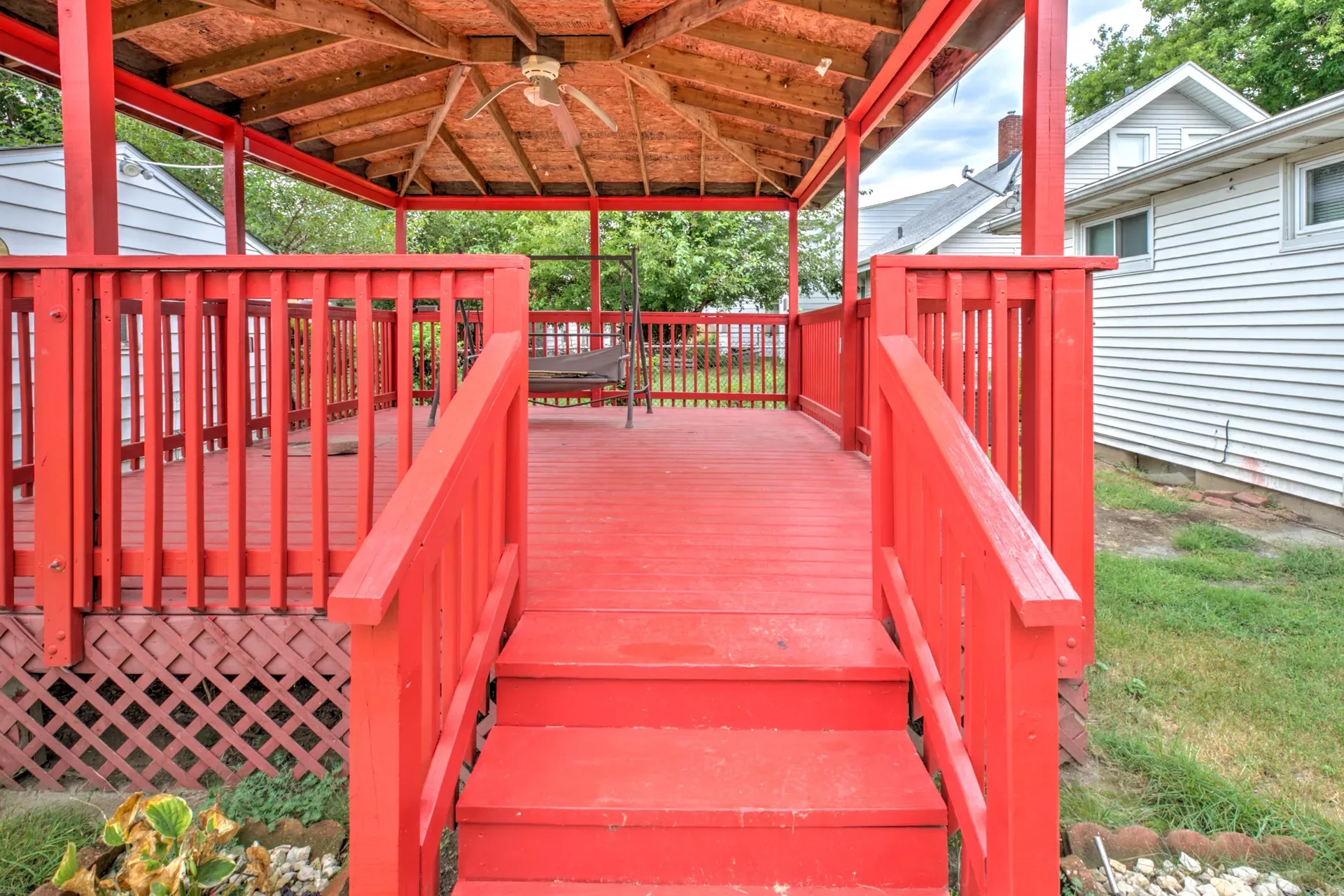Bright red covered deck with a gazebo in the backyard at 902 E Maywood Ave
